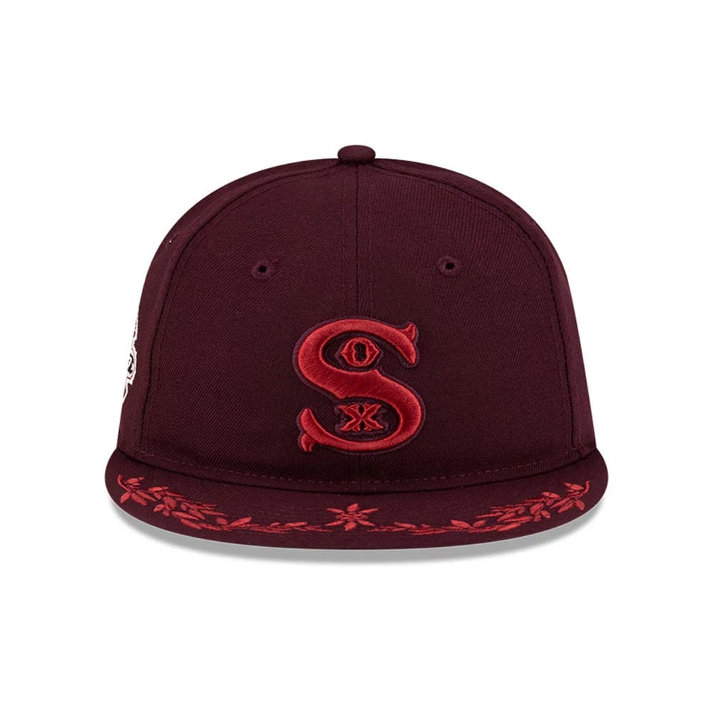 Pictured is this MLB Flourishes Chicago White Sox Retro Crown 9FIFTY cap in dark purple. 2