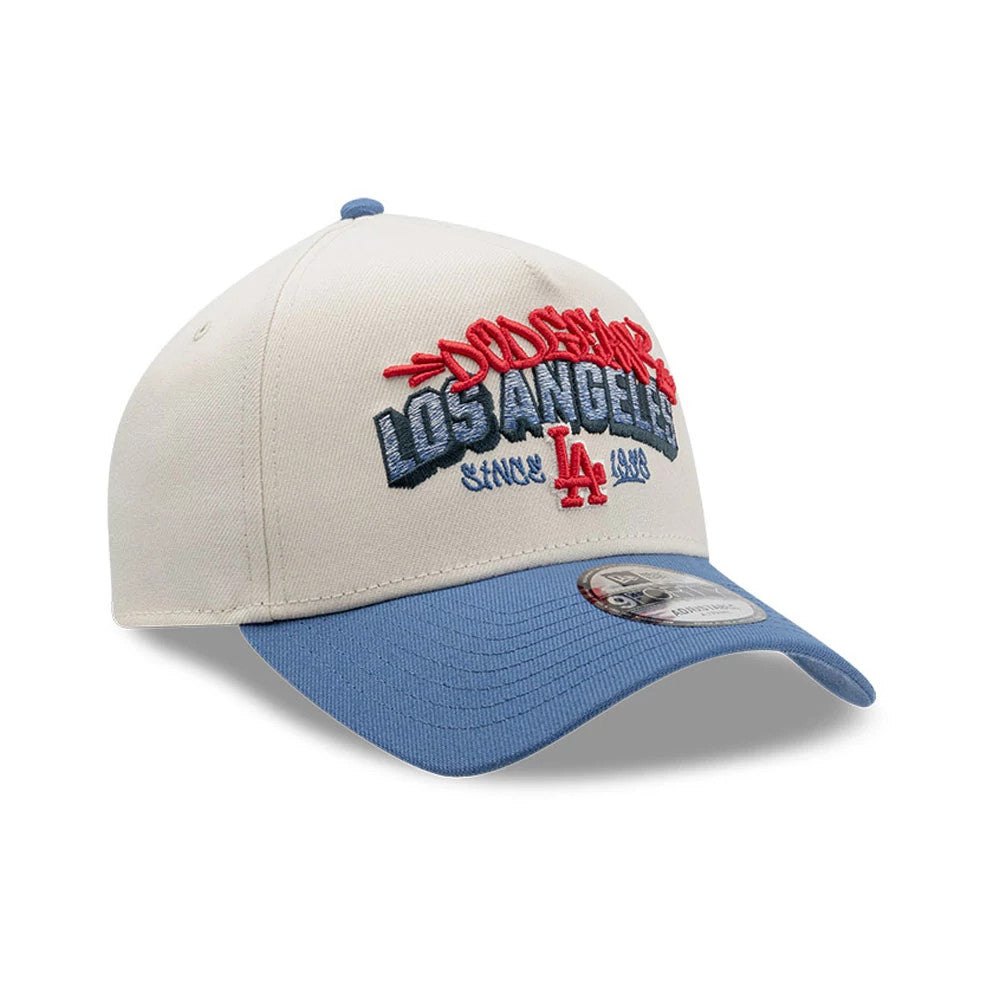 LA Dodgers MLB Tagged Light Beige New Era 9FORTY A-Frame Cap, three-quarter view showing the raised red script Dodgers logo over the blue embroidered Los Angeles text on the front panel, with a blue curved visor and 9FORTY size sticker.