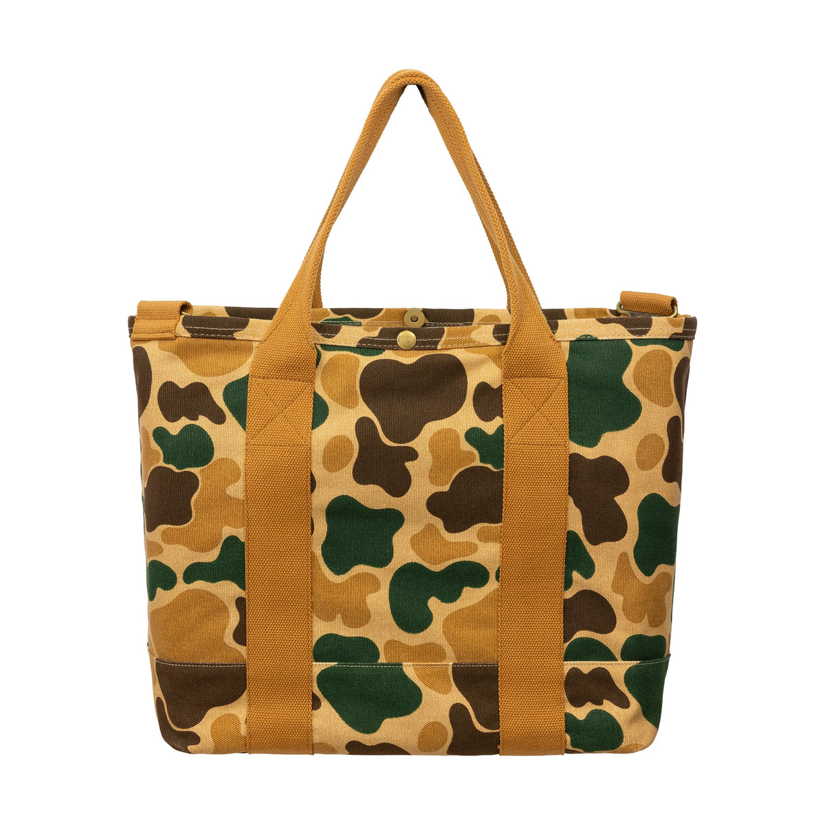New Era Duck Camo Tote Bag, front view showing the camo pattern with shades of green, brown and tan, two tan shoulder straps running vertically down the front, and a gold-tone button closure at the top centre.