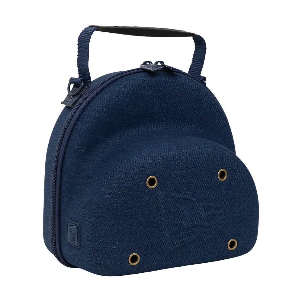 New Era Denim Navy 2Pk 59FIFTY Cap Carrier, side view showing the structured navy shell with a zip closure along the edge, a short handle attached to the top, debossed New Era logo near the base and eyelets on the surface.