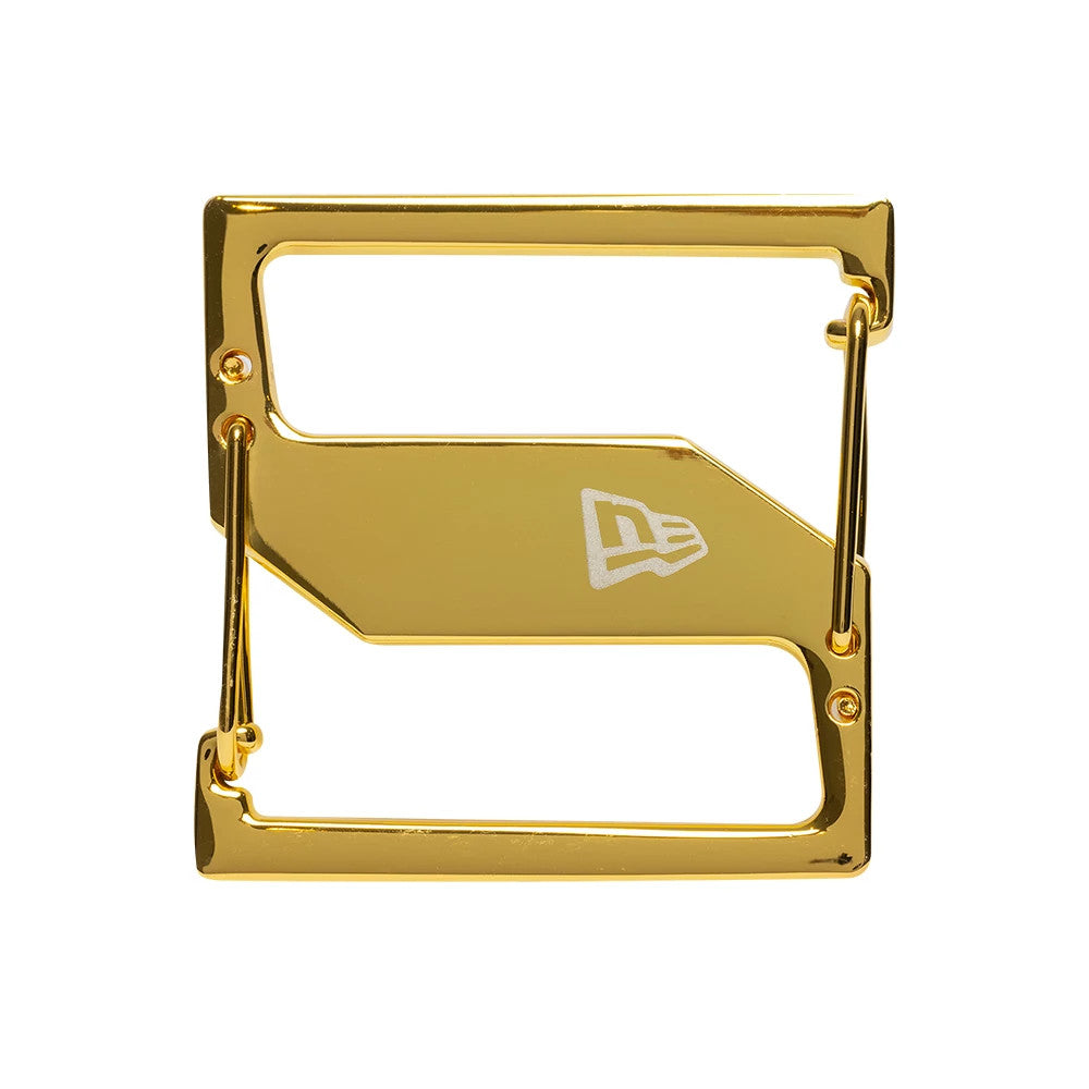 New Era Gold Cap Clip, front view showing a rectangular gold clip with a polished finish, featuring the New Era flag logo in white on the central plate, and two pins extending from opposite sides.