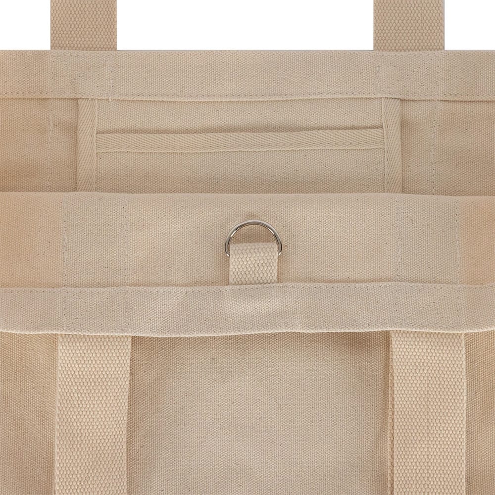 New Era New York Yankees MLB Script Light Beige Tote Bag, back view showing a light beige design with reinforced handles, a D-ring detail attached to a loop on the upper back section, and stitch along the edges.