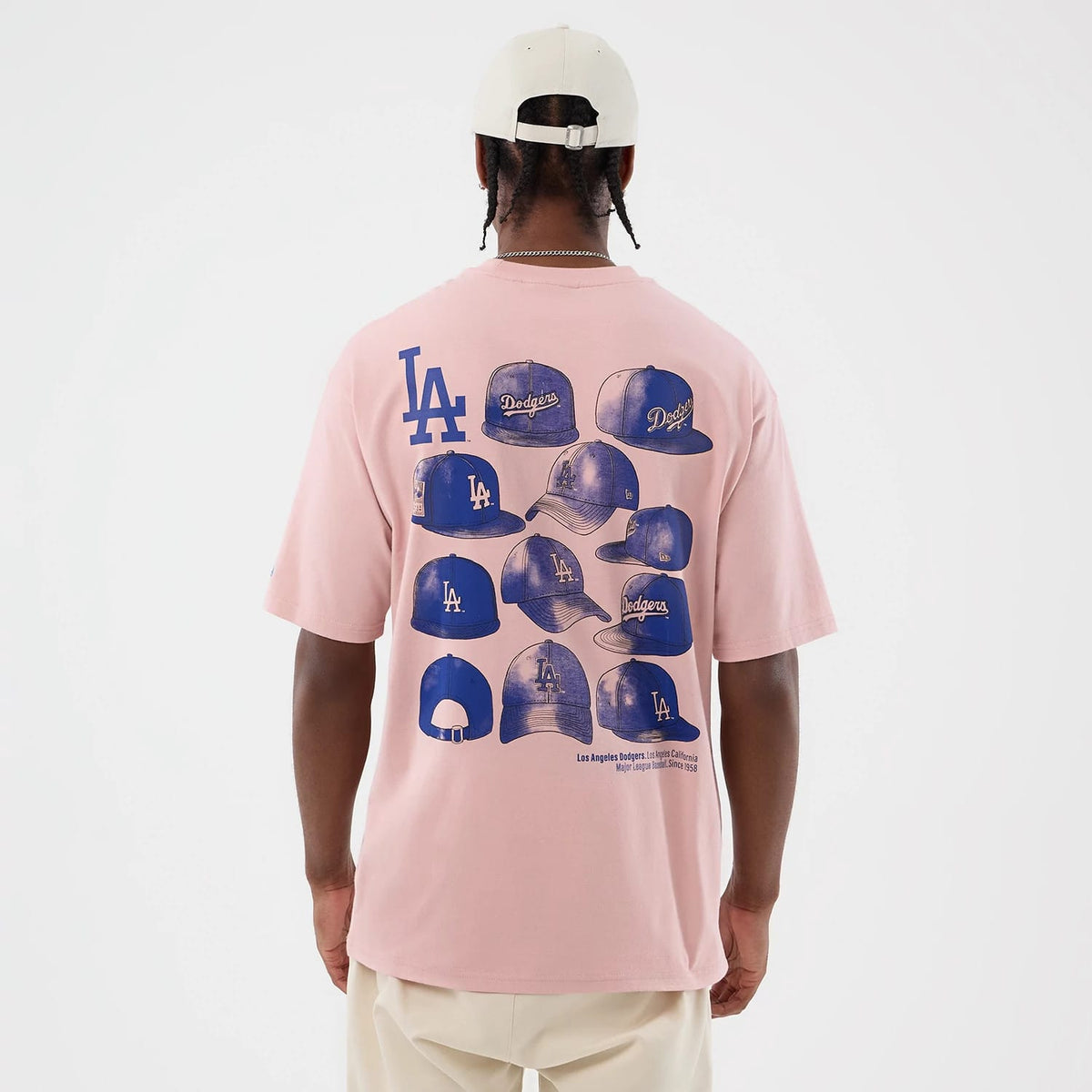 The model is wearing this MLB Cap Graphic LA Dodgers Oversized T-Shirt in pastel pink. 2