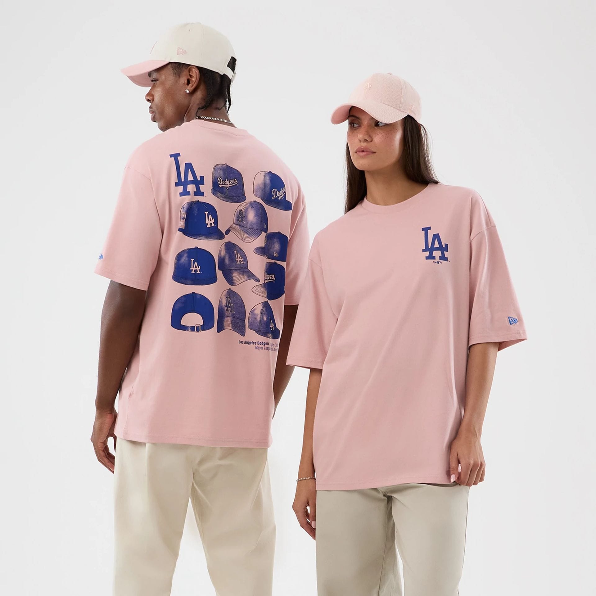 The model is wearing this MLB Cap Graphic LA Dodgers Oversized T-Shirt in pastel pink. 1