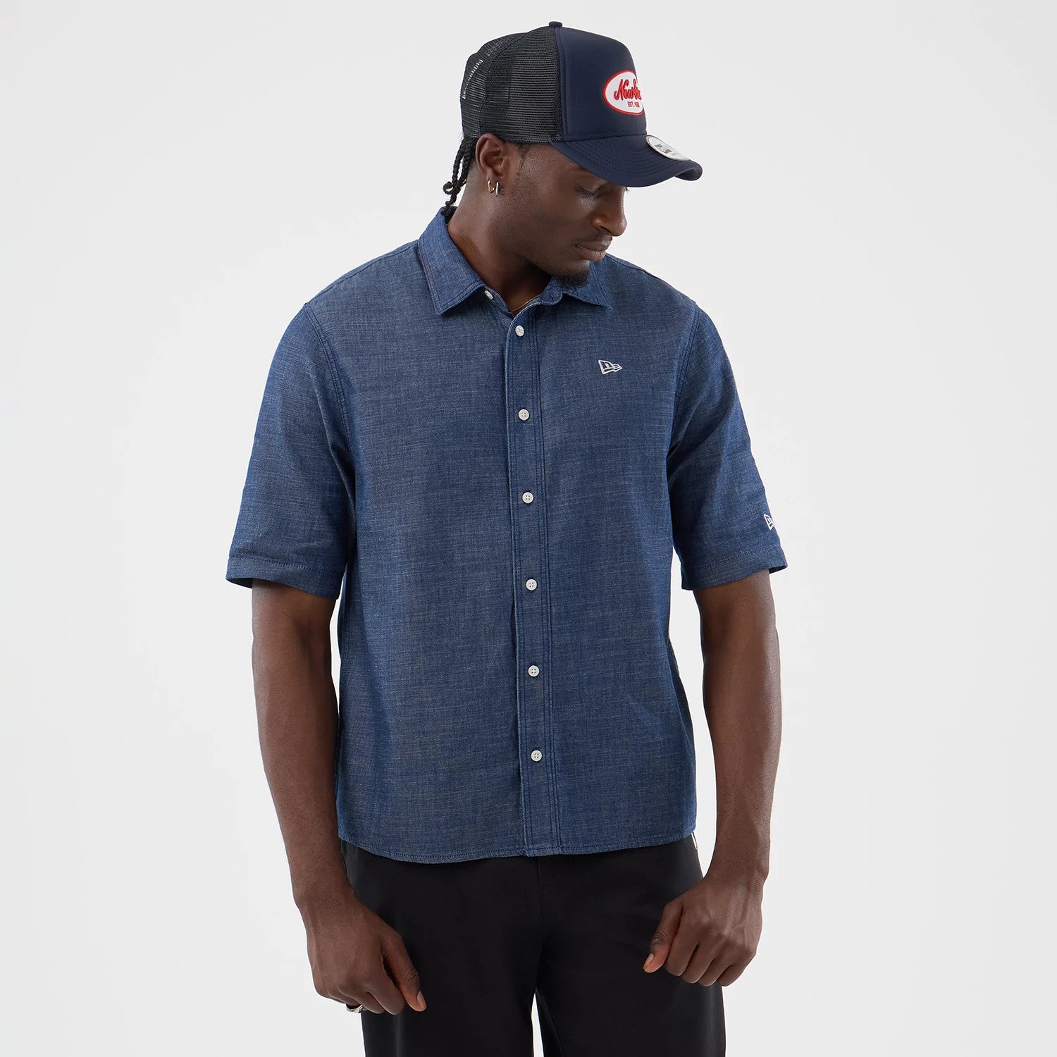The model is wearing this New Era Denim Short Sleeve Shirt in blue. 3