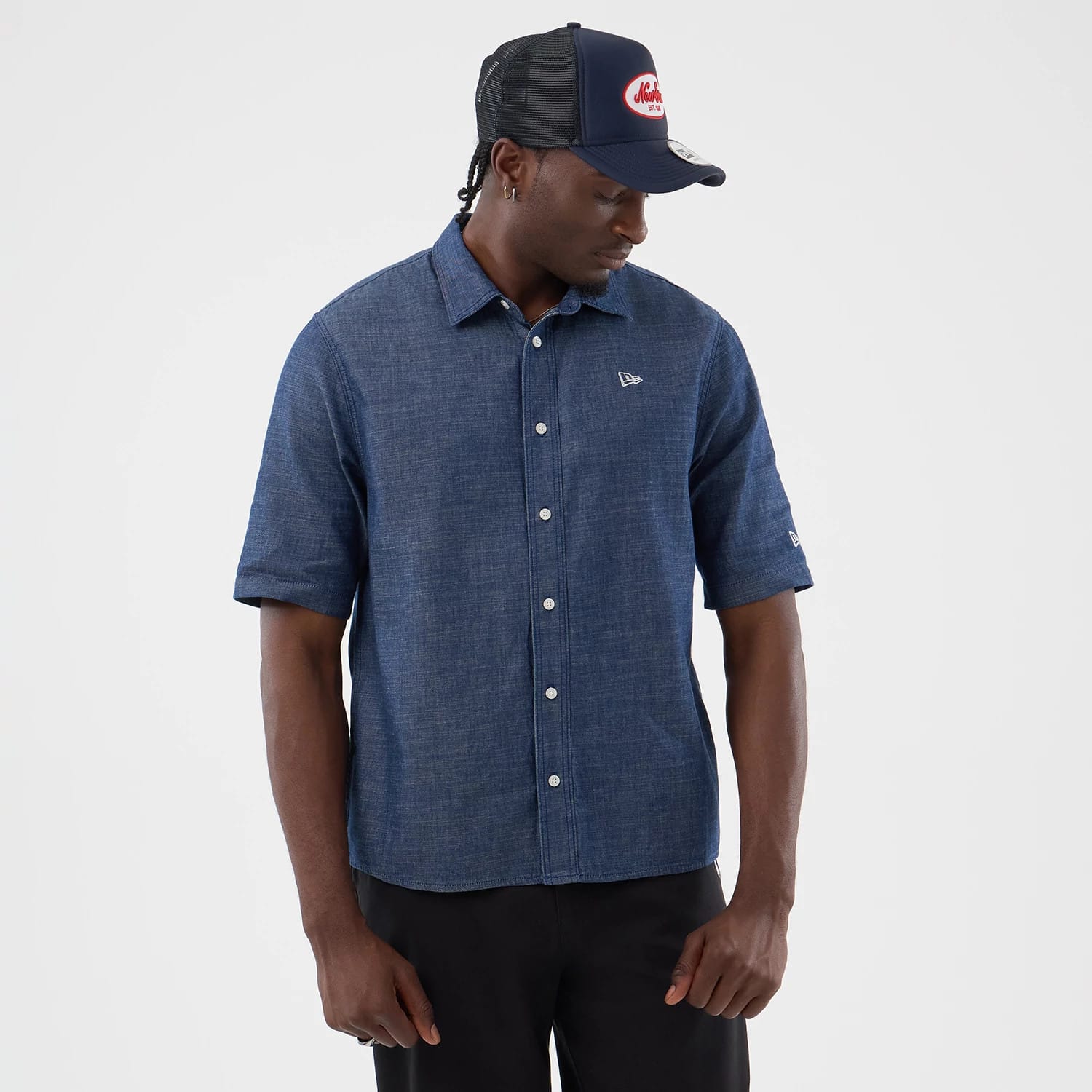 The model is wearing this New Era Denim Short Sleeve Shirt in blue. 3