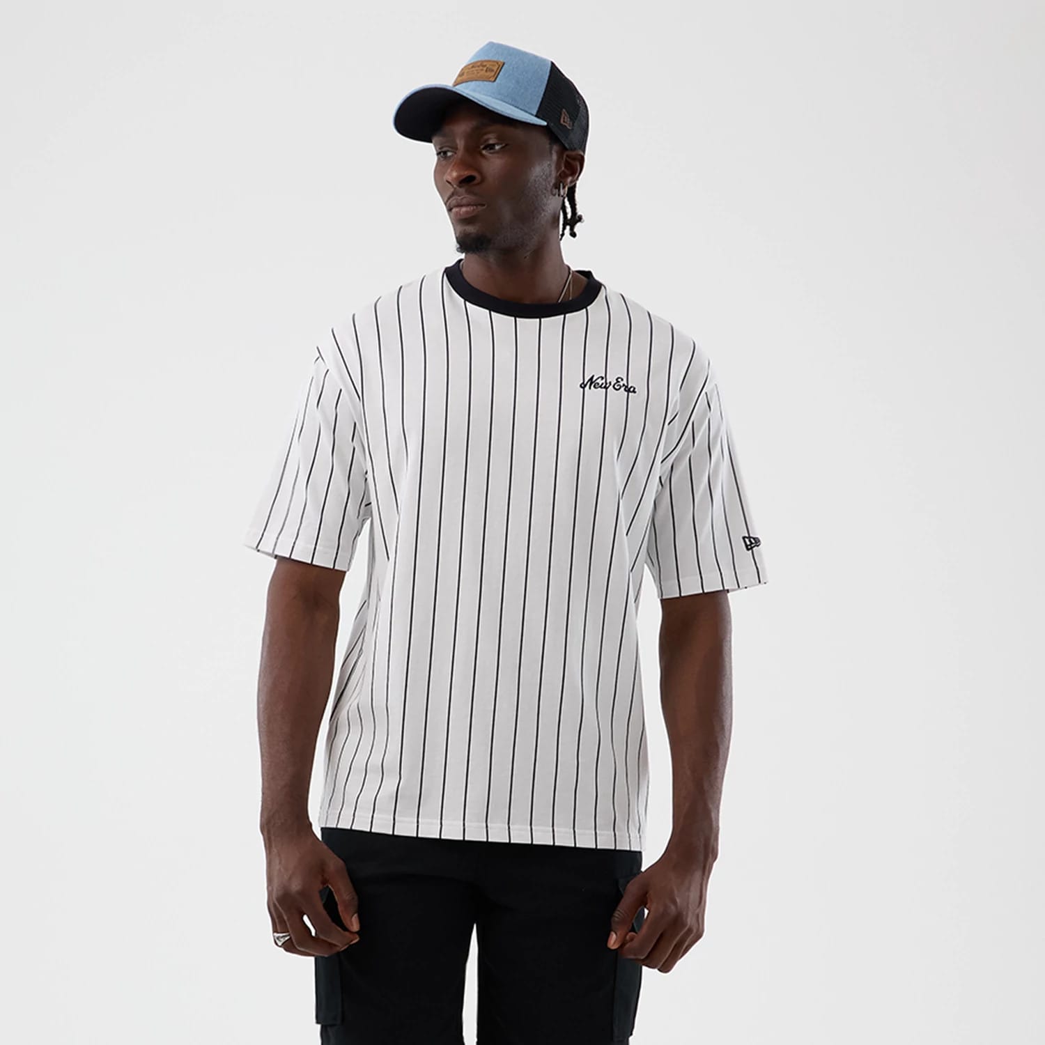 The model is wearing this New Era Pinstripe Oversized T-Shirt in Open White. 1