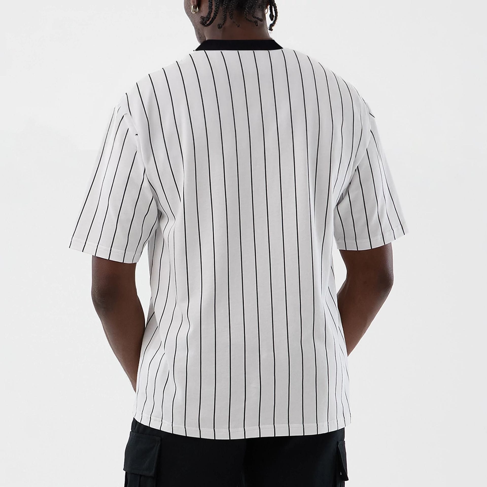 The model is wearing this New Era Pinstripe Oversized T-Shirt in Open White. 2