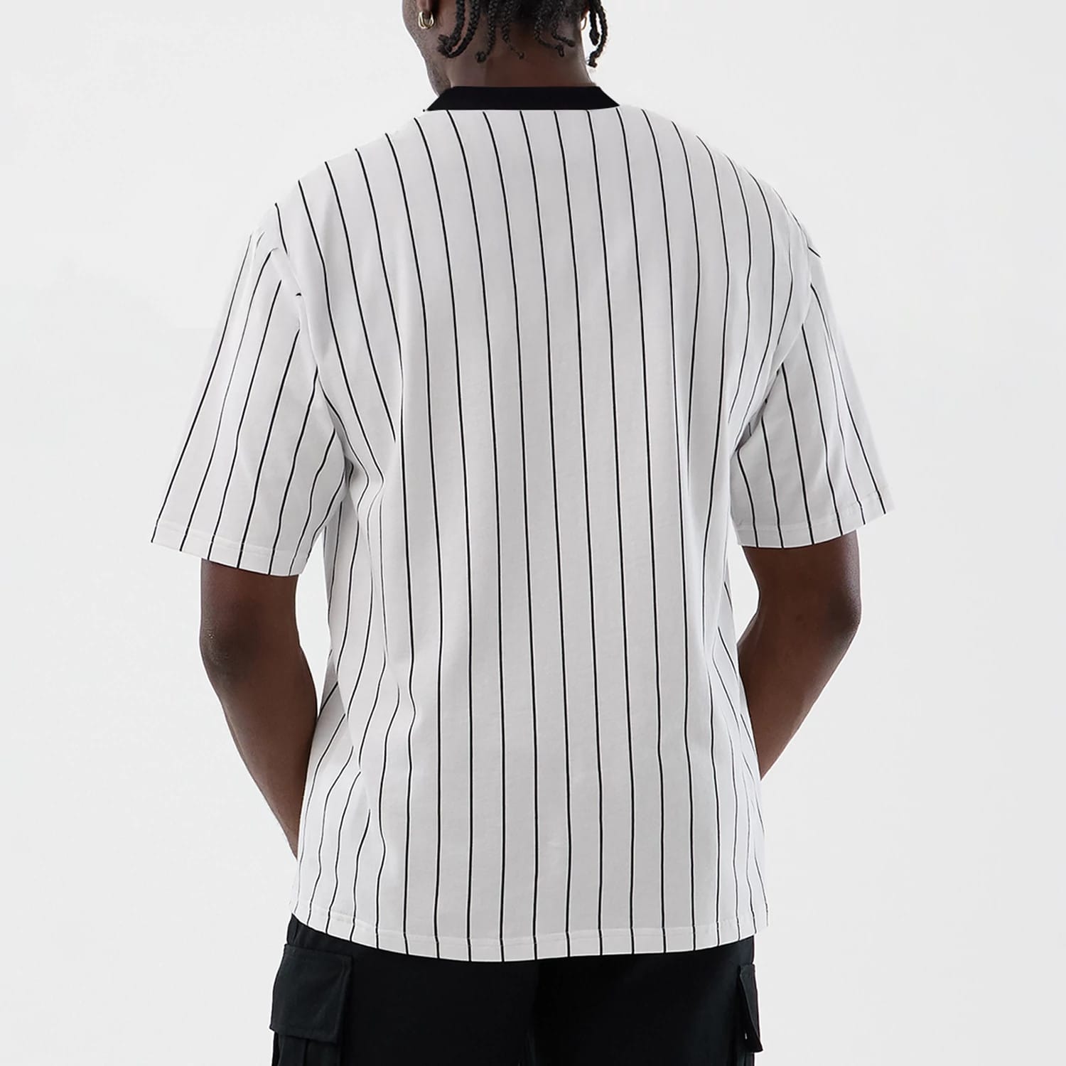 The model is wearing this New Era Pinstripe Oversized T-Shirt in Open White. 2
