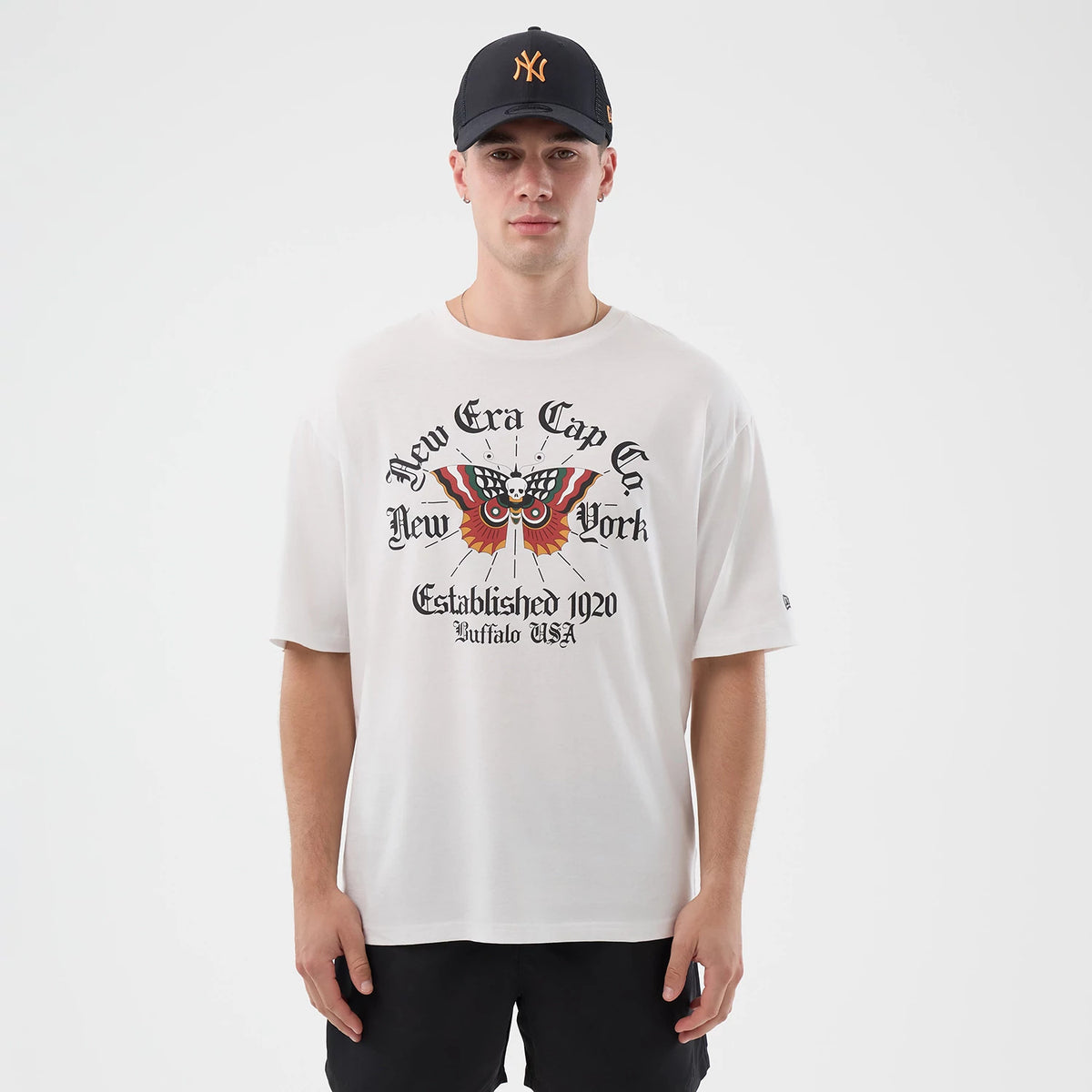 New Era Death Moth Graphic White Oversized T-Shirt, front view on a model showing a detailed death moth graphic across the chest with New Era Cap Co. New York lettering above, Established 1920 Buffalo USA lettering below.