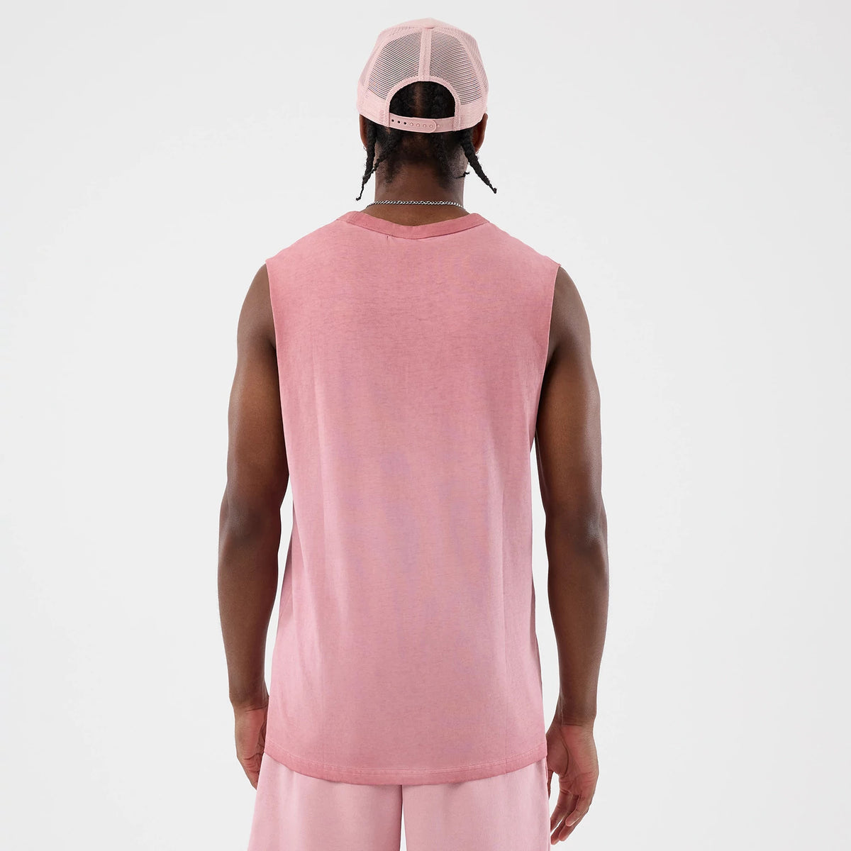 New Era New York Yankees MLB Washed Logo Pastel Pink Vest, back view on a model with a coordinating pale pink mesh cap, showing the sleeveless design and relaxed fit, complementing pastel pink shorts for a casual look.