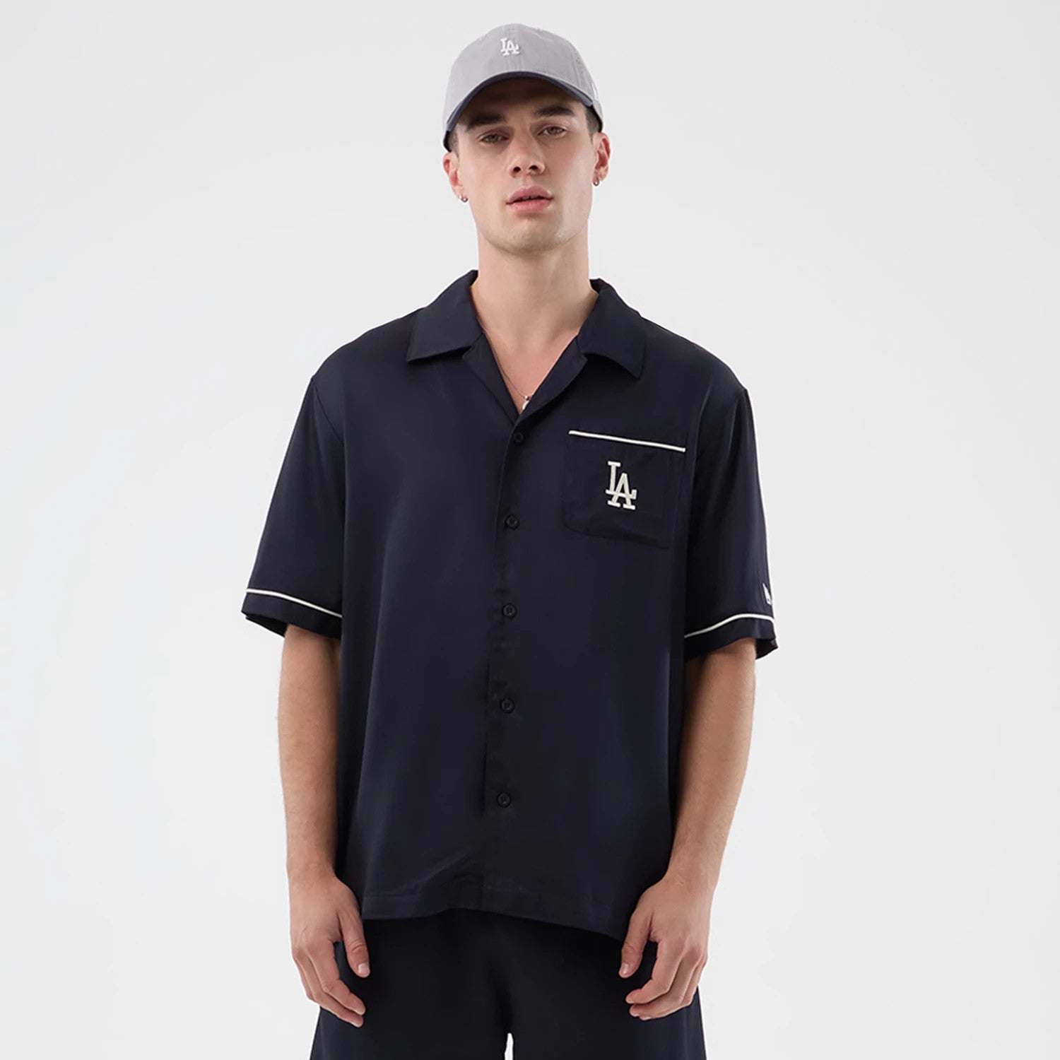 The model is wearing this MLB Graphic Revere LA Dodgers Short Sleeve Shirt in navy. 1