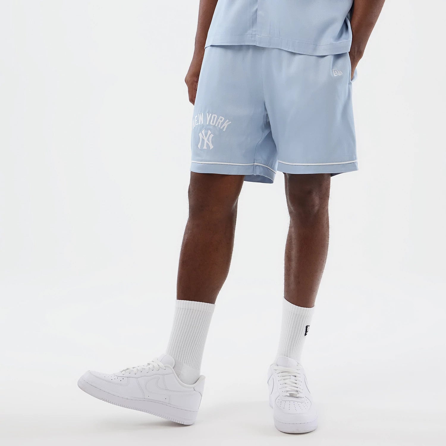 The model is wearing this MLB Woven New York Yankees Shorts in pastel blue. 3