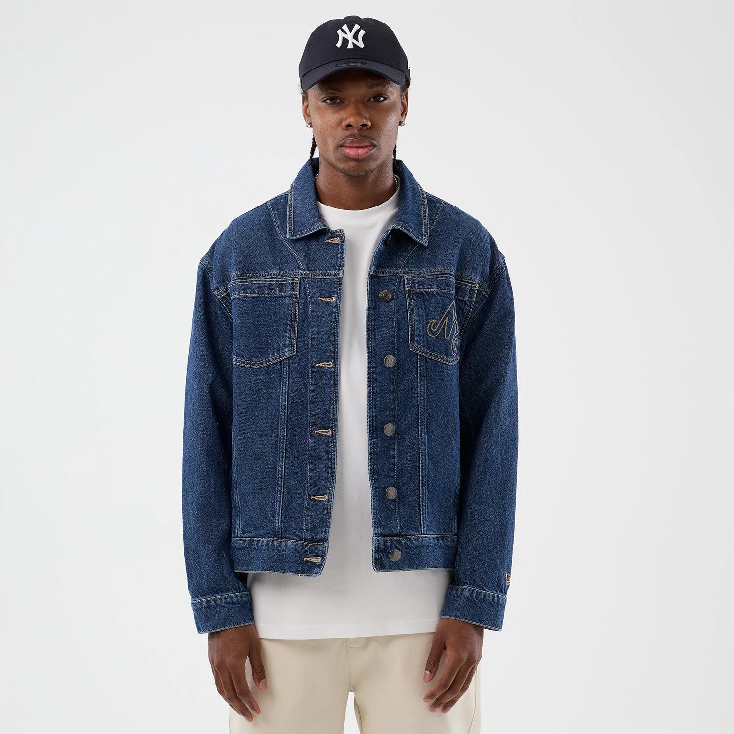 The model is wearing this New Era Script Denim Jacket in dark blue. 3