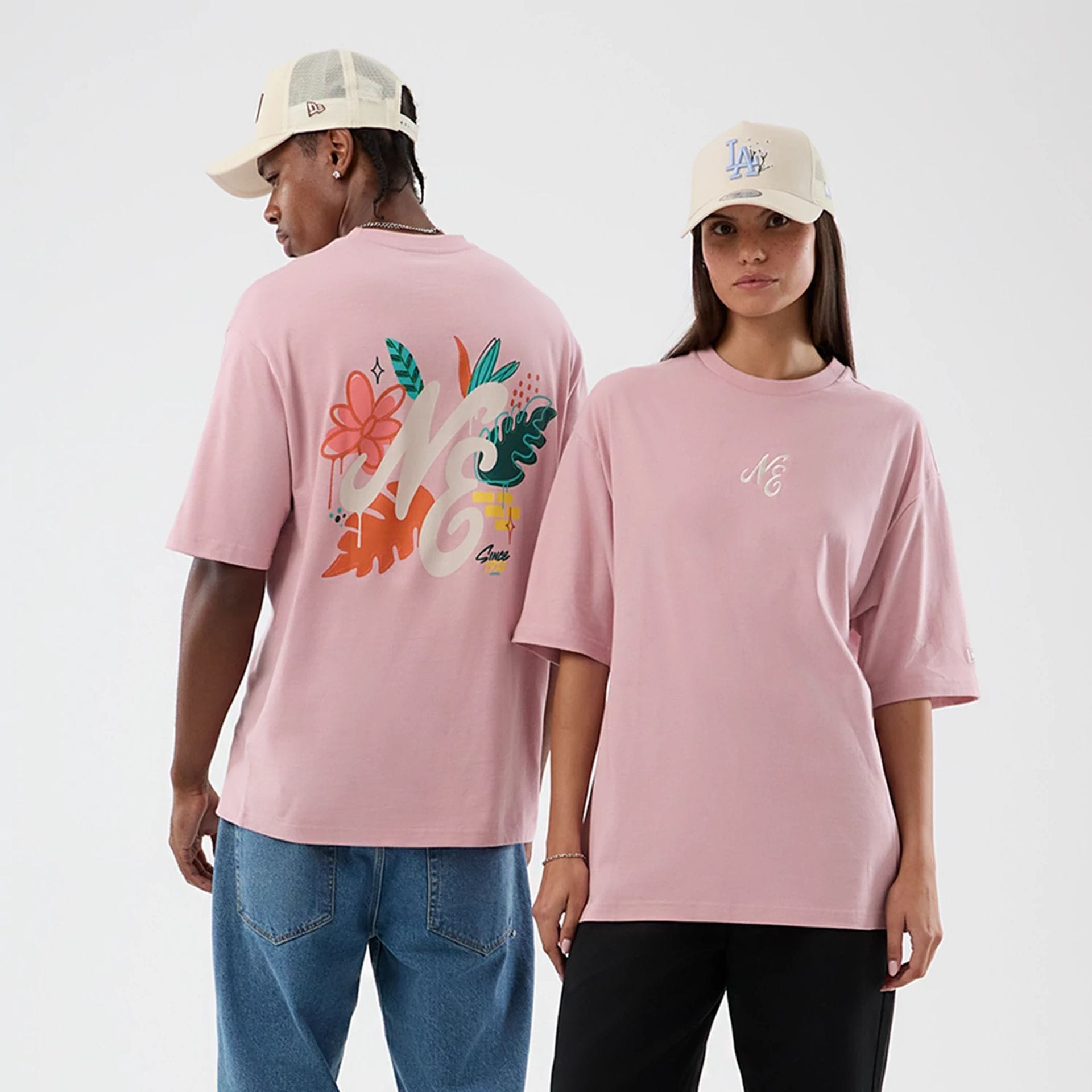 The model is wearing this New Era Floral Graphic Oversized T-Shirt in pastel pink. 1