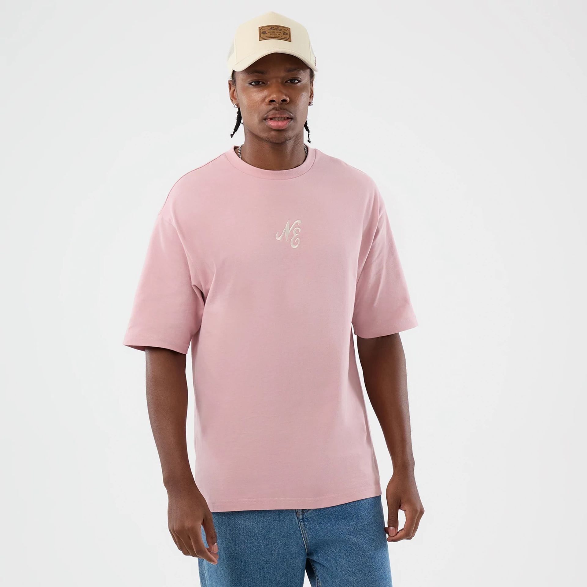 The model is wearing this New Era Floral Graphic Oversized T-Shirt in pastel pink. 2