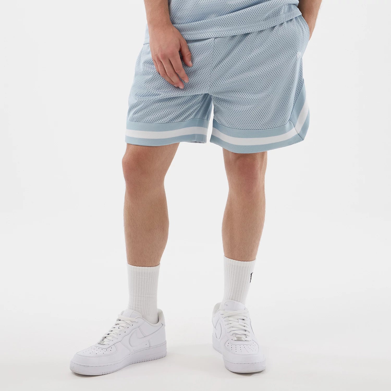 The model is wearing this New Era Mesh Oversized Shorts in pastel blue. 3