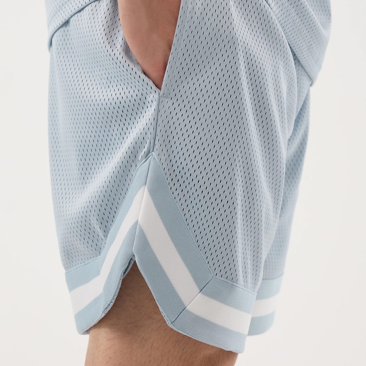 The model is wearing this New Era Mesh Oversized Shorts in pastel blue. 4