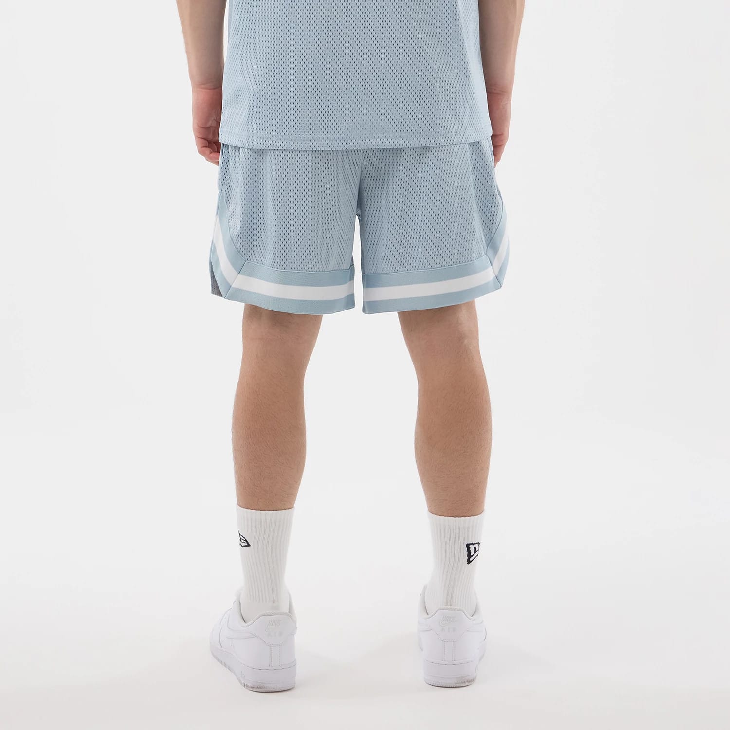 The model is wearing this New Era Mesh Oversized Shorts in pastel blue. 2