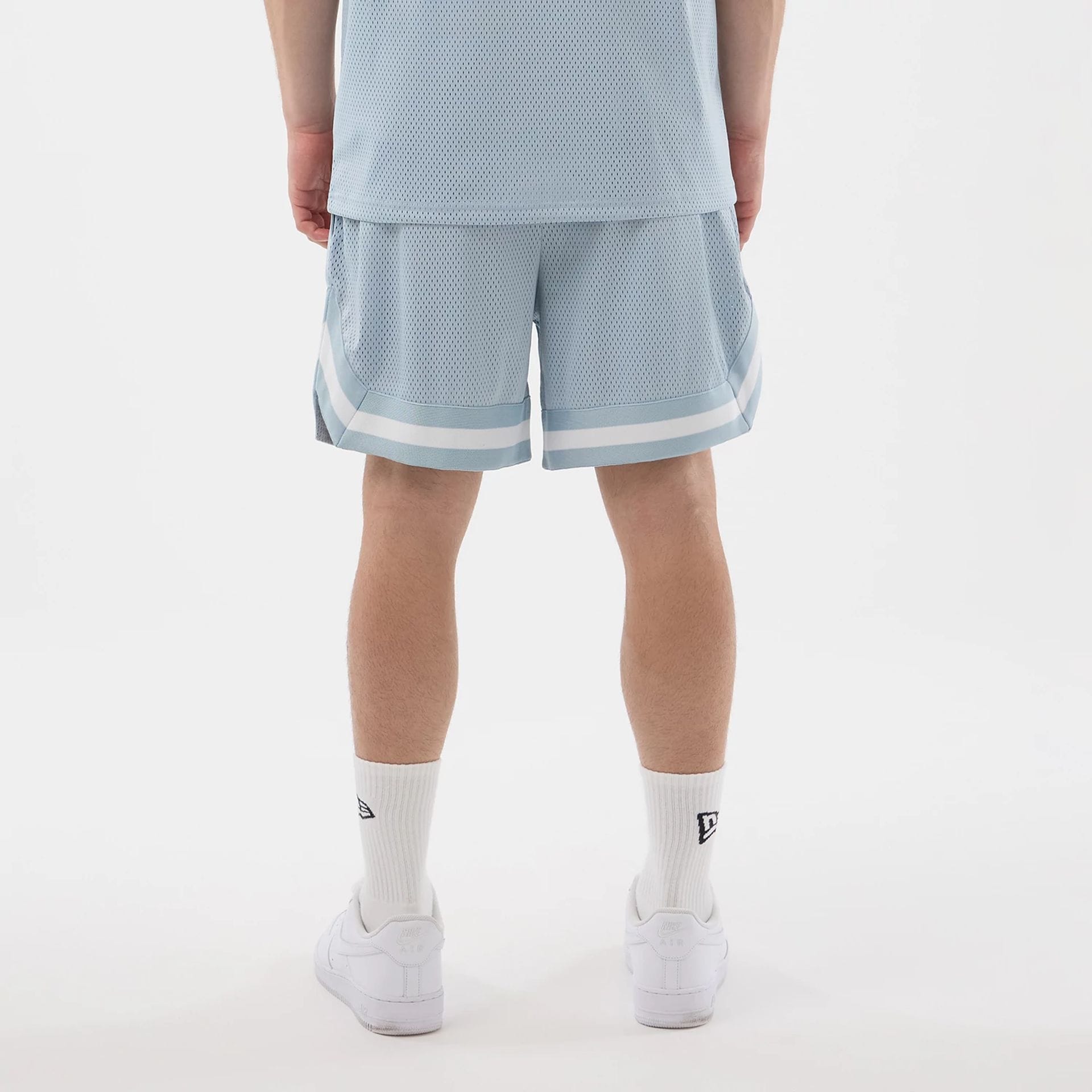 The model is wearing this New Era Mesh Oversized Shorts in pastel blue. 2