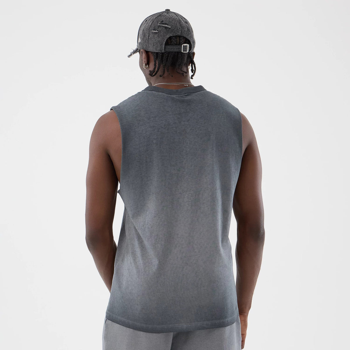 New Era New York Yankees MLB Washed Logo Black Vest, back view on a model with a grey cap, featuring a faded black wash design, cut-off sleeves, and a longline fit for a casual and relaxed look.