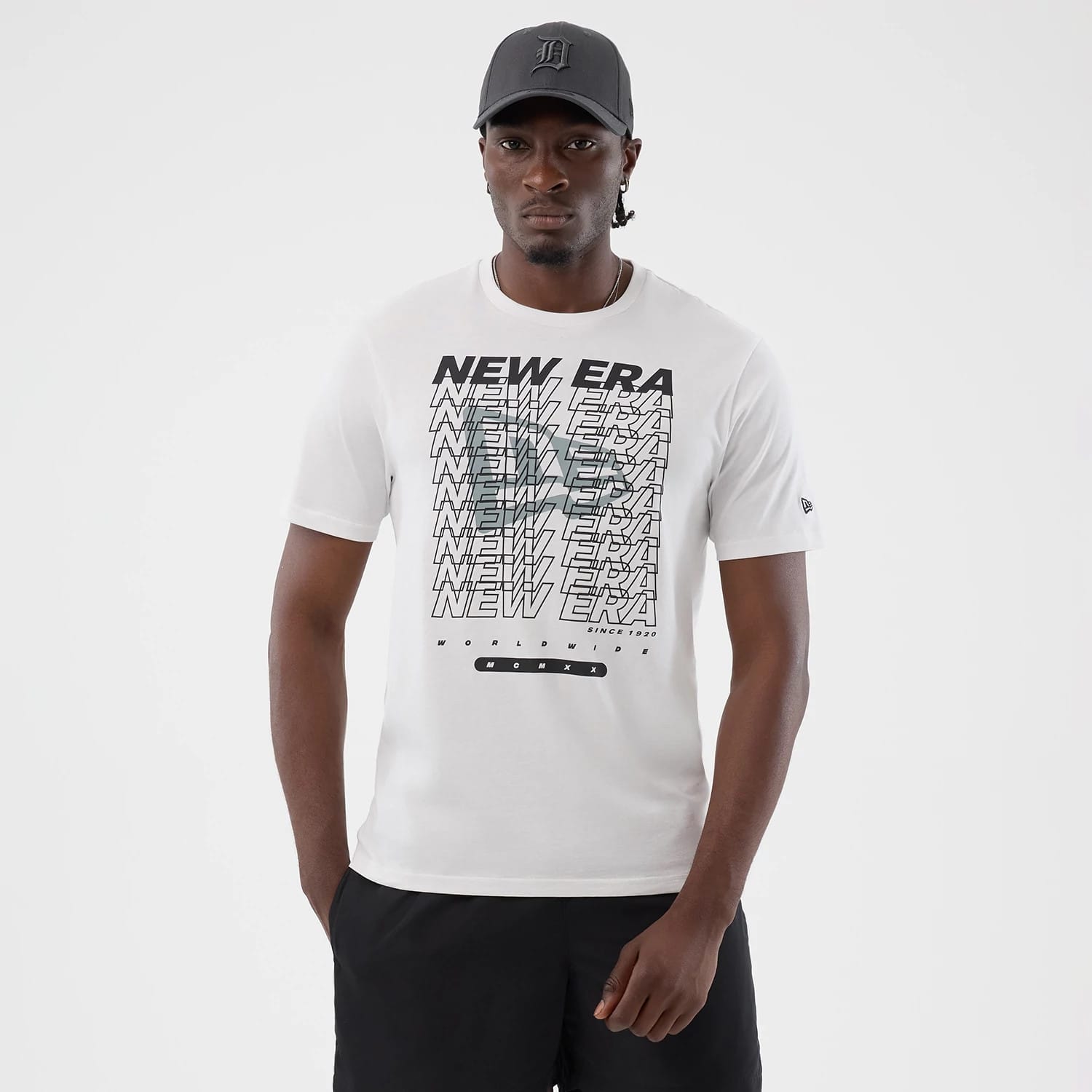 The model is wearing this New Era Logo Graphic T-Shirt in white. 1