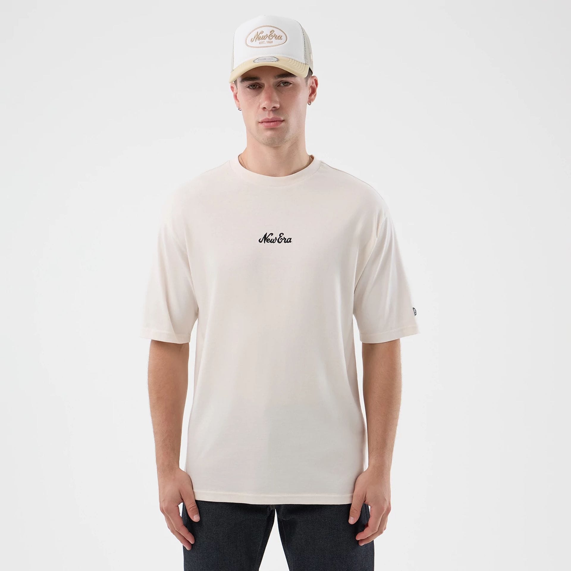 The model is wearing this New Era Floral Graphic Oversized T-Shirt in open white. 1