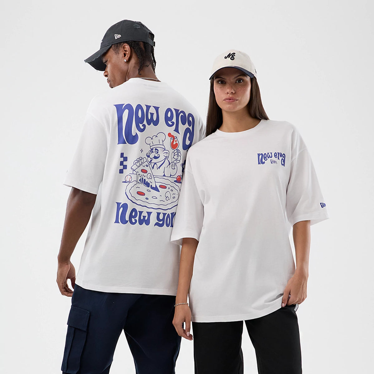 New Era Fun Pizza Graphic White Oversized T-Shirt, front and back view on-model showing a playful pizza graphic with a chef and red details, blue New Era New York lettering on the back, and a small matching logo on the left chest.