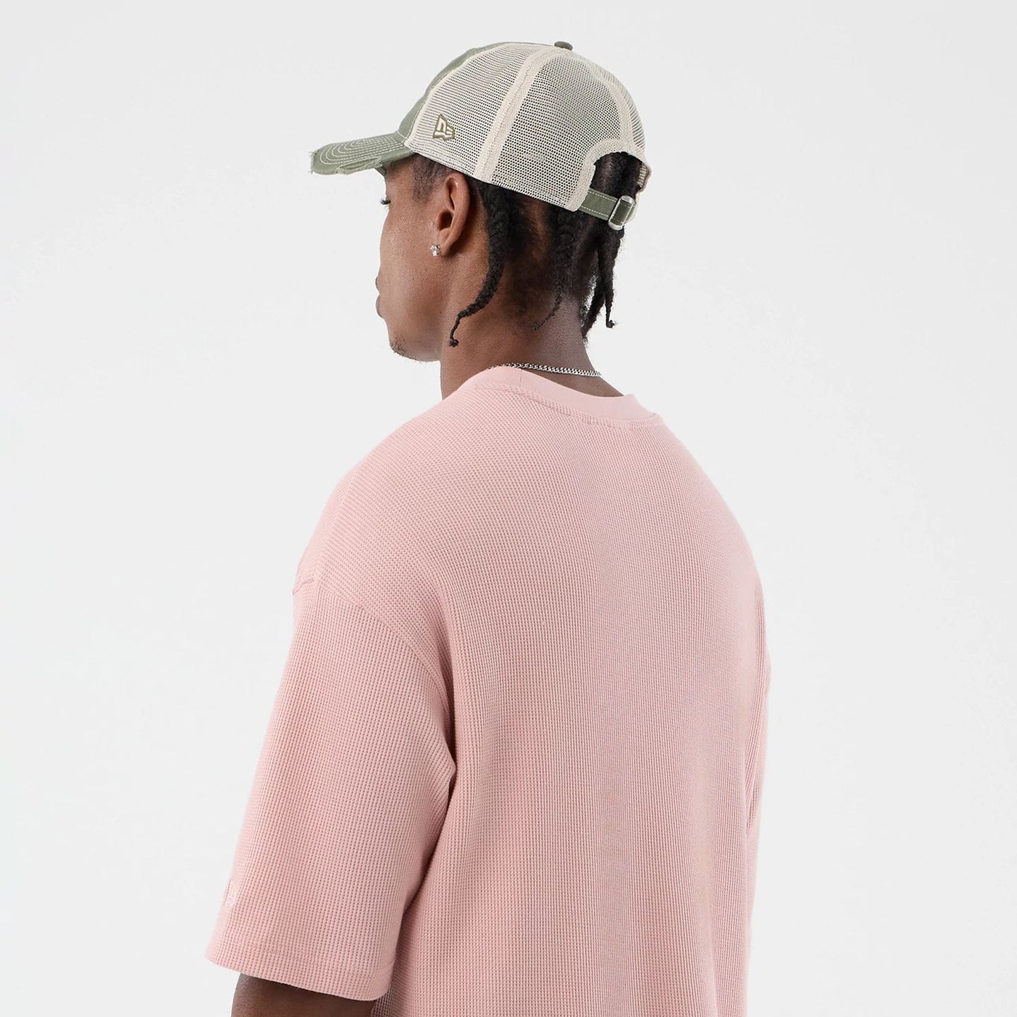 The model is wearing this New Era Waffle T-Shirt in pastel pink. 8