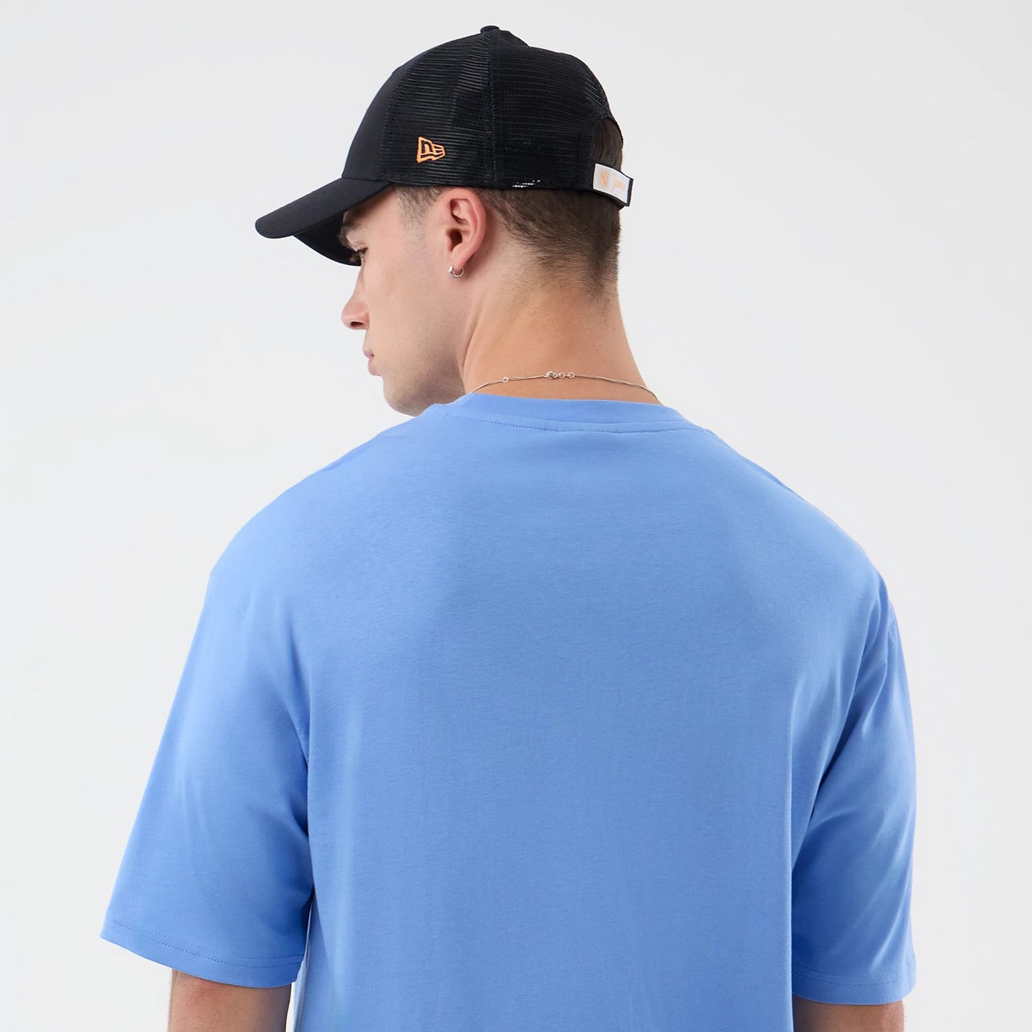 The model is wearing this New Era Basketball Character Graphic T-Shirt in pastel blue. 8