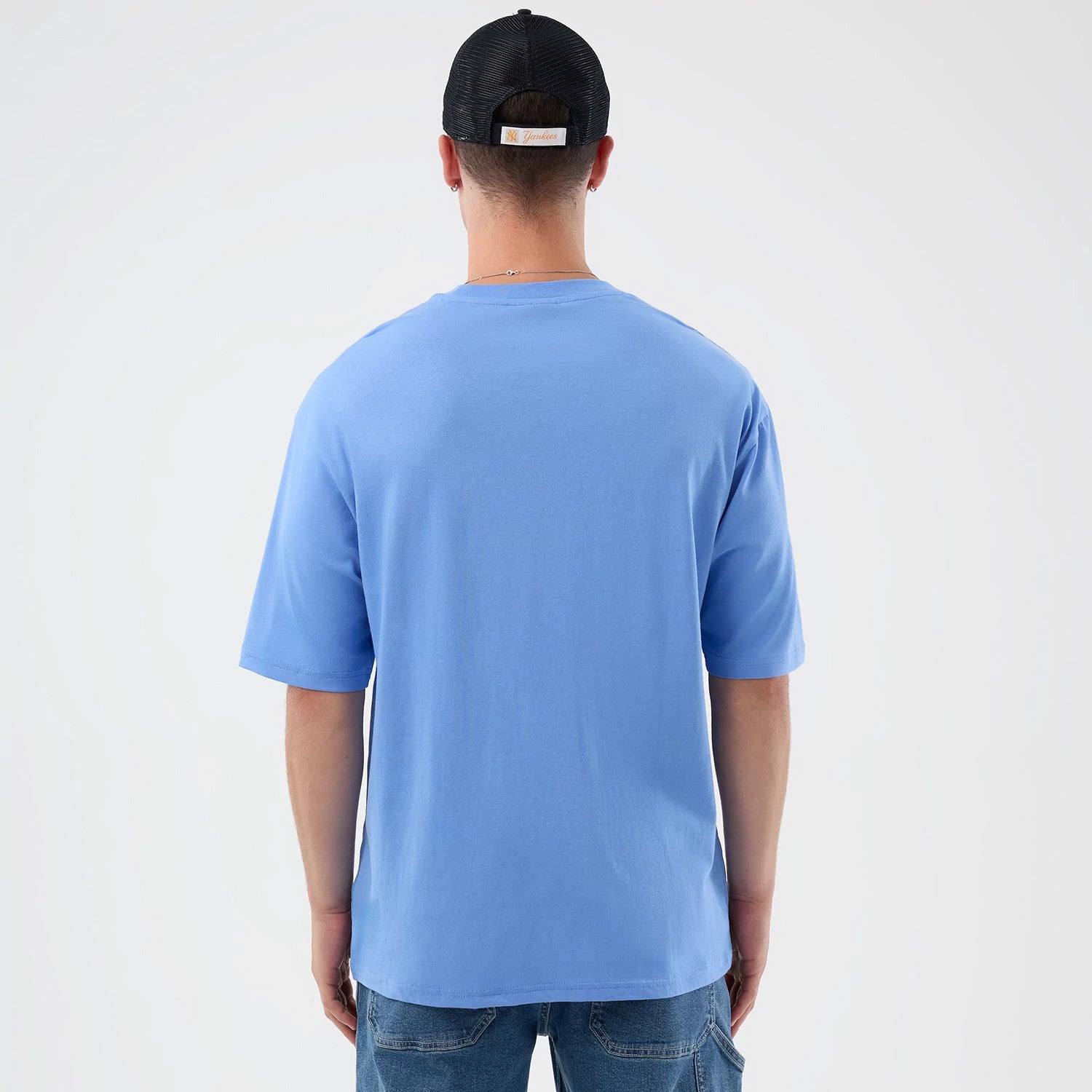 The model is wearing this New Era Basketball Character Graphic T-Shirt in pastel blue. 2