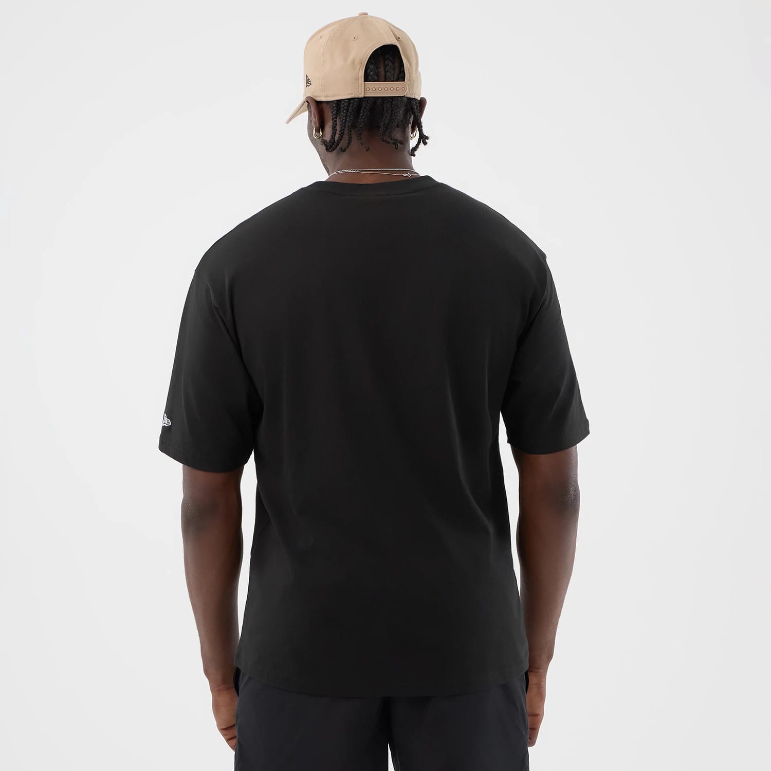 The model is wearing this New Era Serpent Graphic Oversized T-Shirt in black. 2