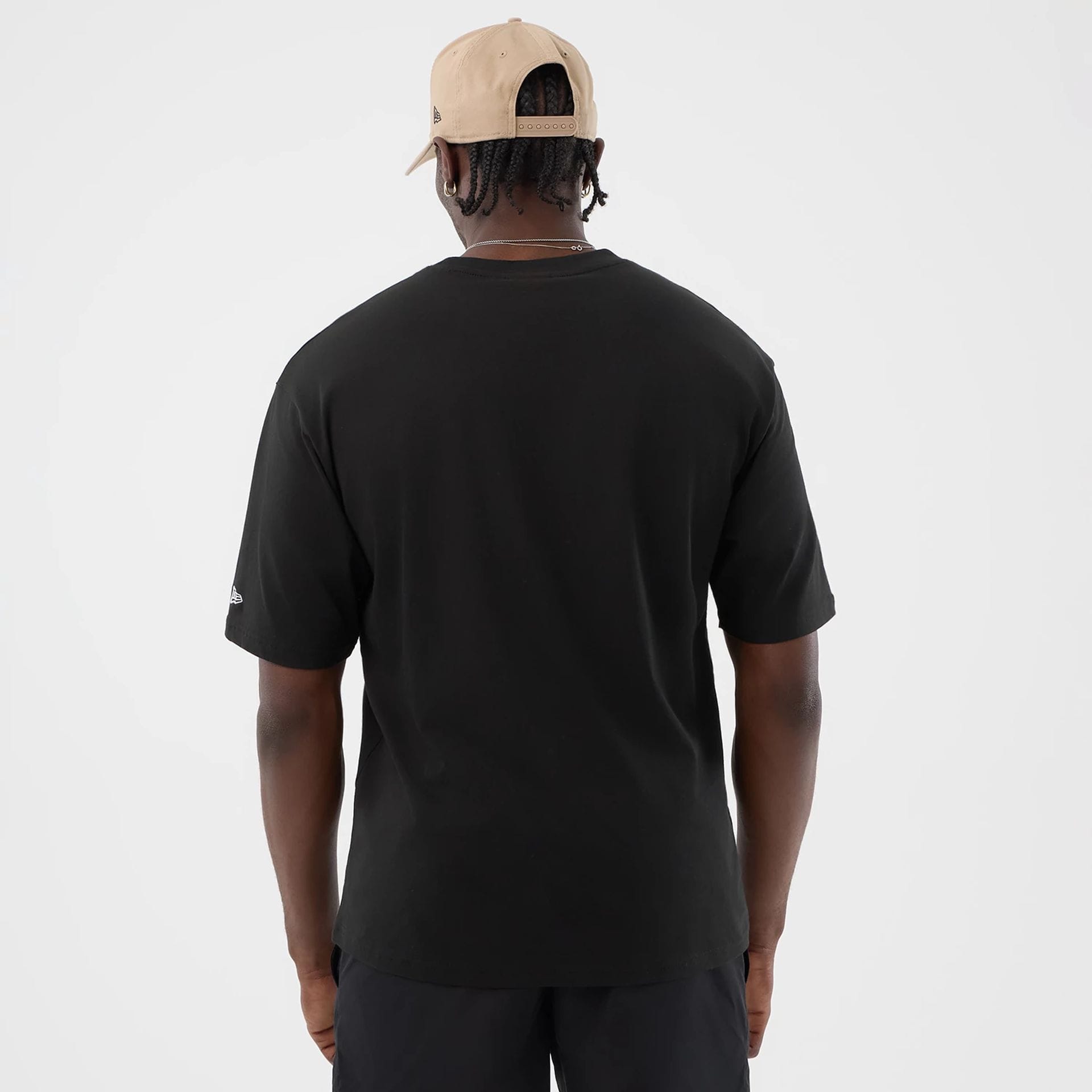 The model is wearing this New Era Serpent Graphic Oversized T-Shirt in black. 2