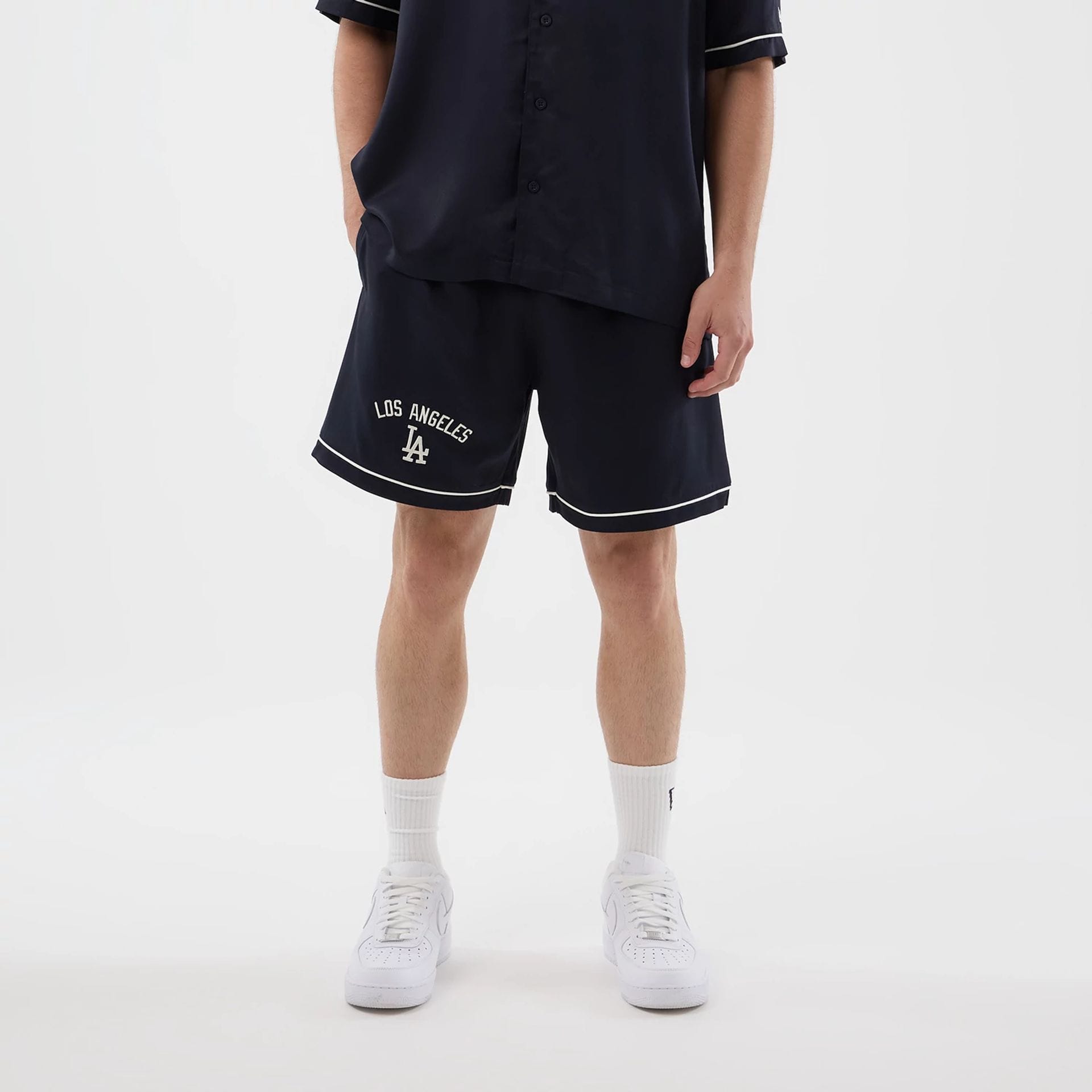 The model is wearing this MLB Woven LA Dodgers Shorts in navy. 1