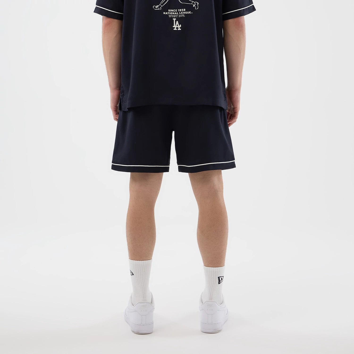 The model is wearing this MLB Woven LA Dodgers Shorts in navy. 2