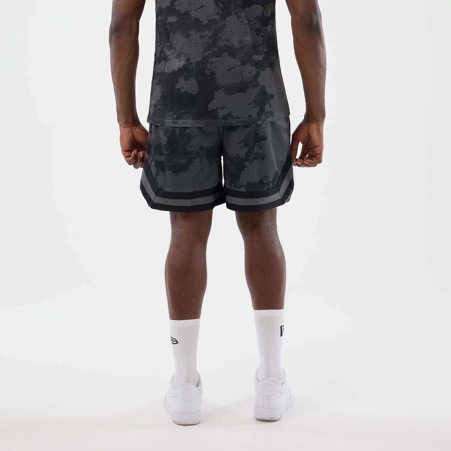 The model is wearing this New Era All Over Print Mesh Shorts in black camo. 2