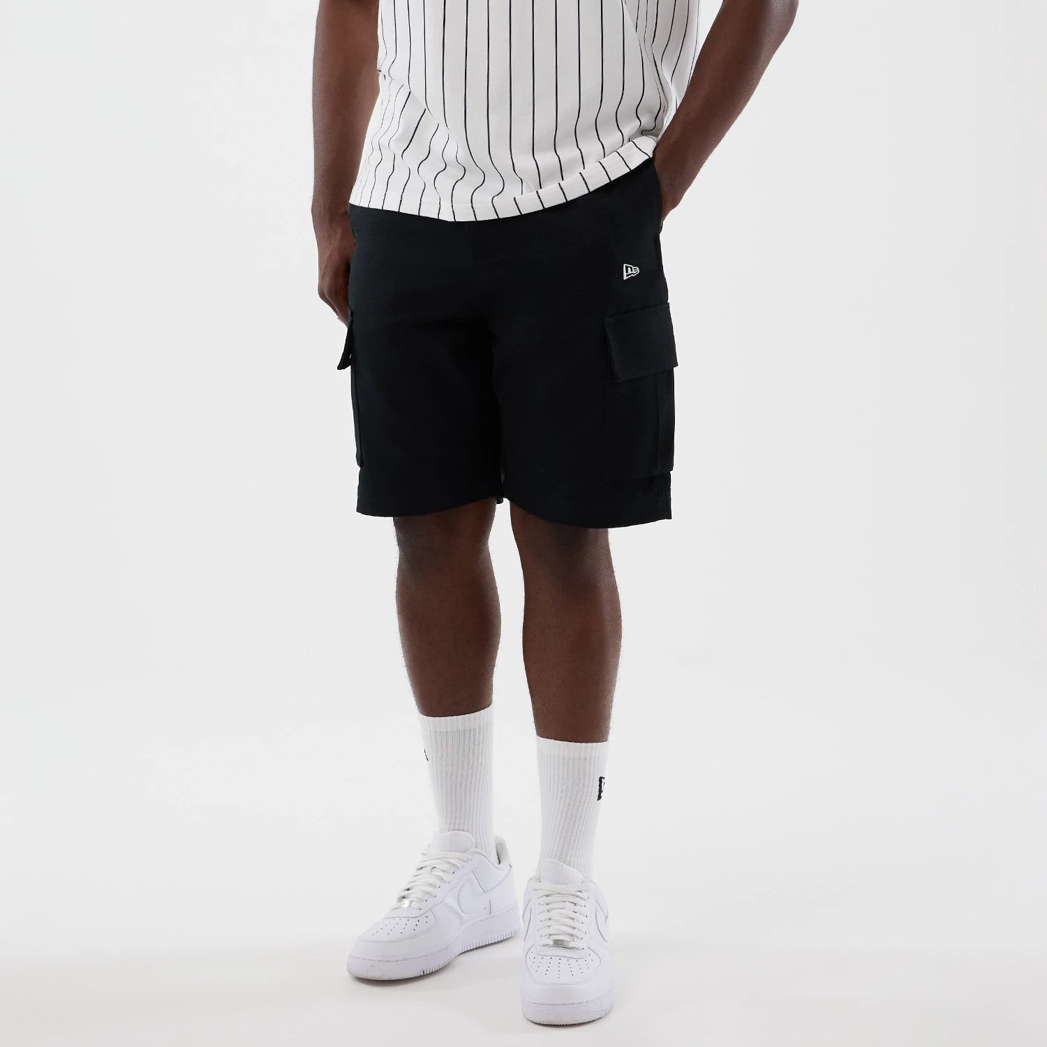 The model is wearing this New Era Cargo Shorts in black. 3