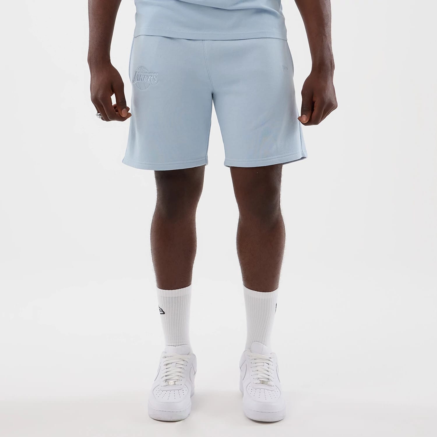 The model is wearing this NBA League Essential LA Lakers Shorts in pastel blue. 1