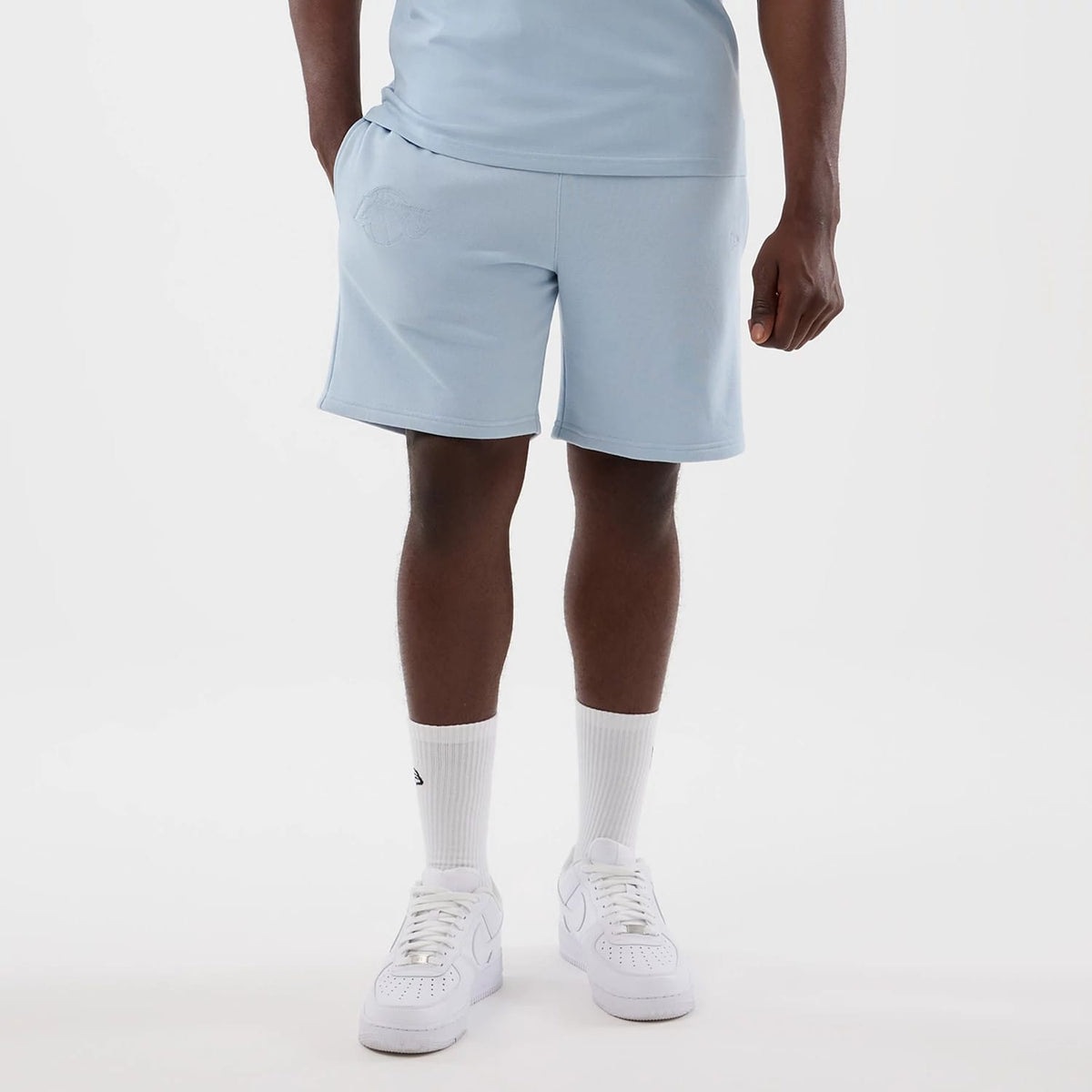 The model is wearing this NBA League Essential LA Lakers Shorts in pastel blue. 7
