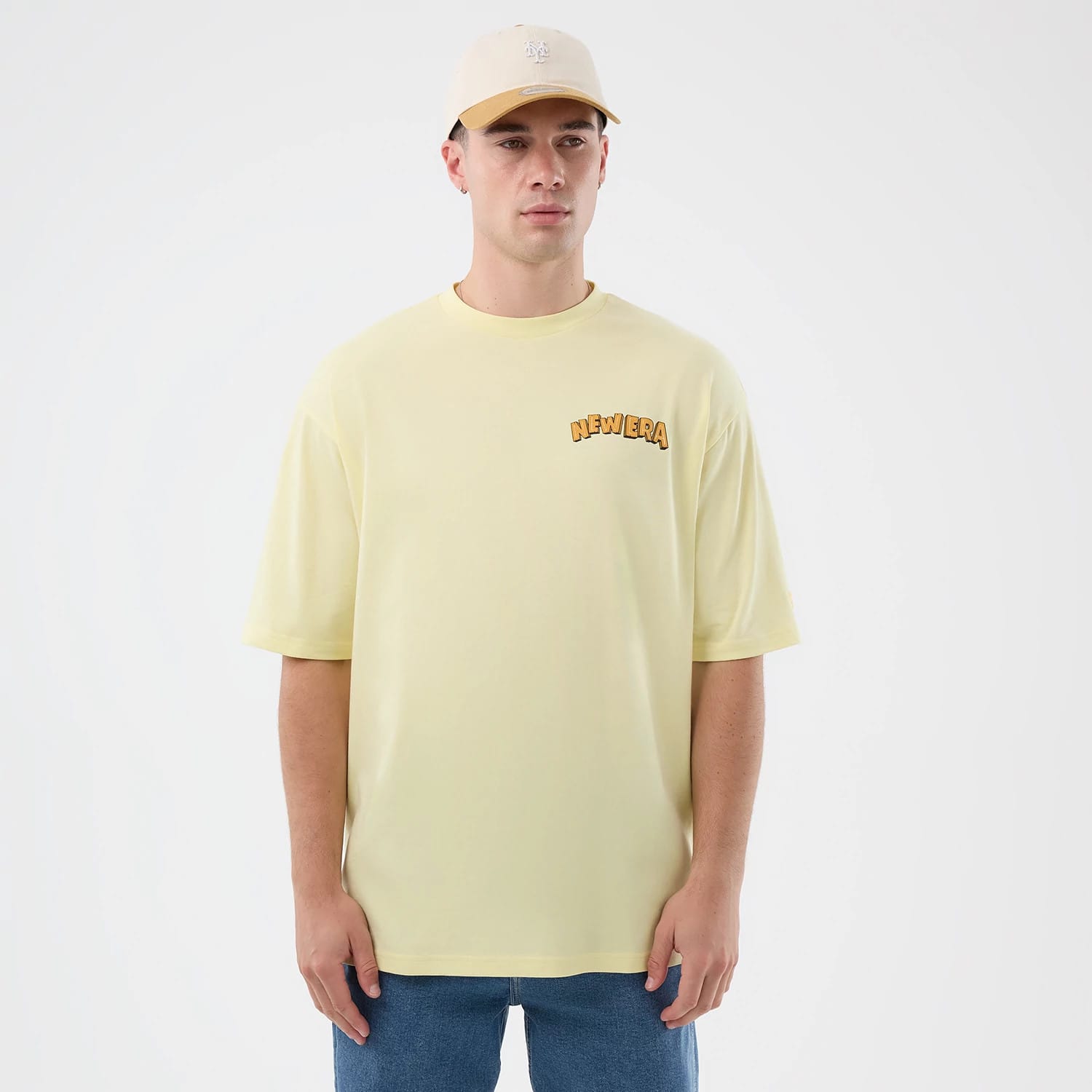 The model is wearing this New Era Fun Beach Party Graphic Oversized T-Shirt in pastel yellow. 3