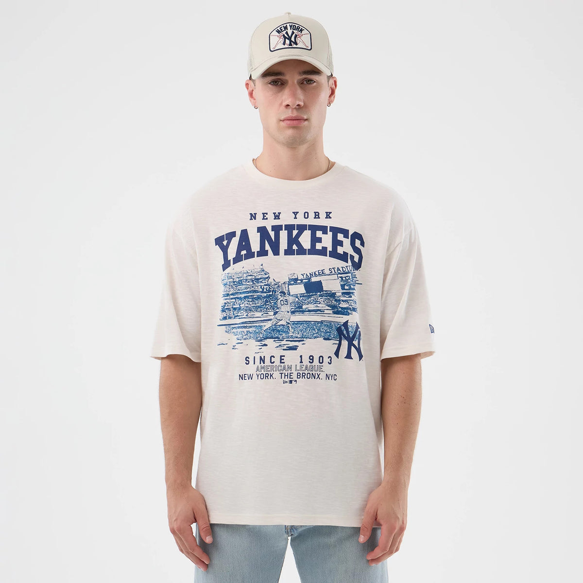 New Era New York Yankees MLB Slub Open White Oversized T-Shirt, front view on-model featuring a large blue graphic of Yankee Stadium and the New York Yankees logo, with 'Yankees' lettering above and a small embroidered New Era logo on the sleeve.