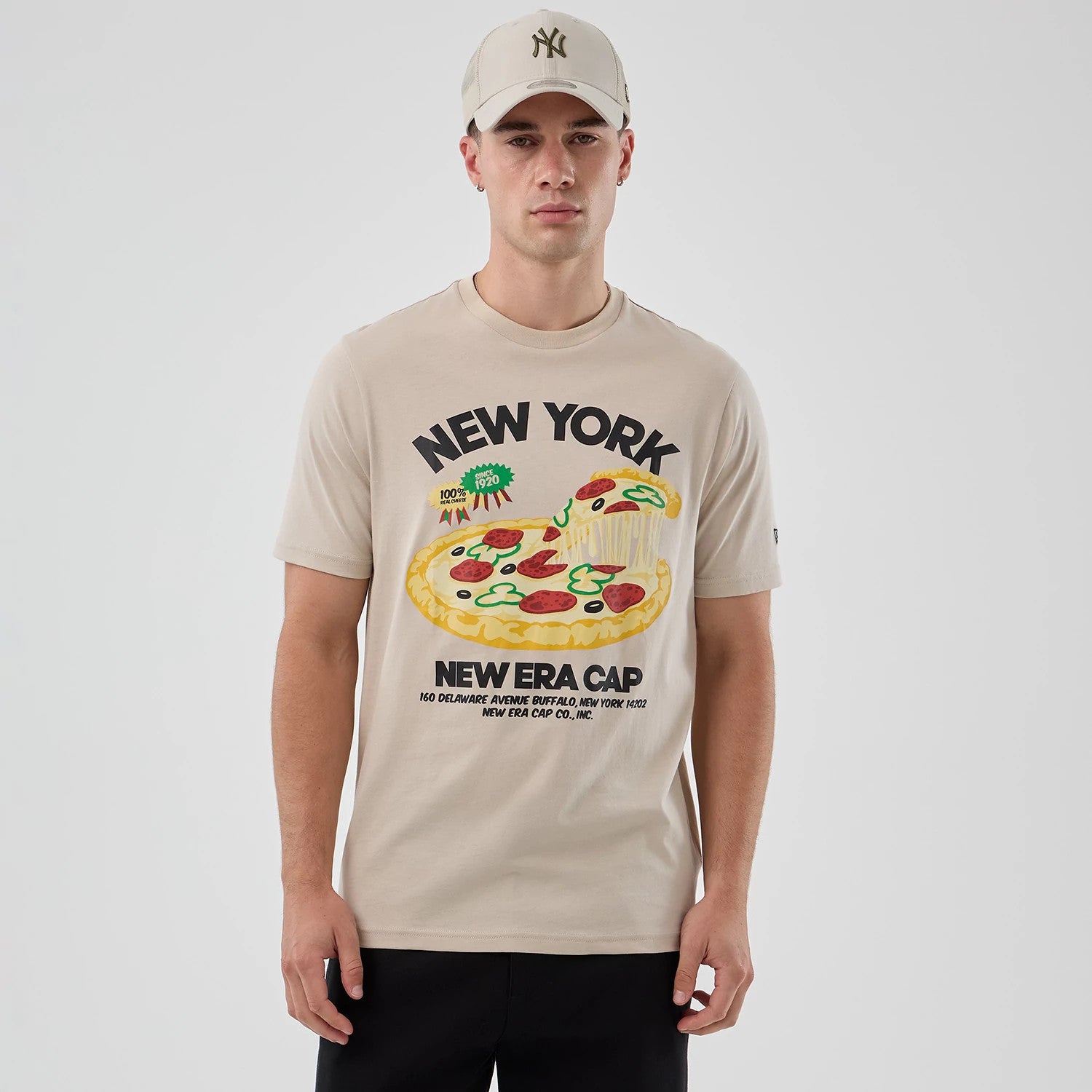 The model is wearing this New Era Pizza Graphic T-Shirt in light beige. 3