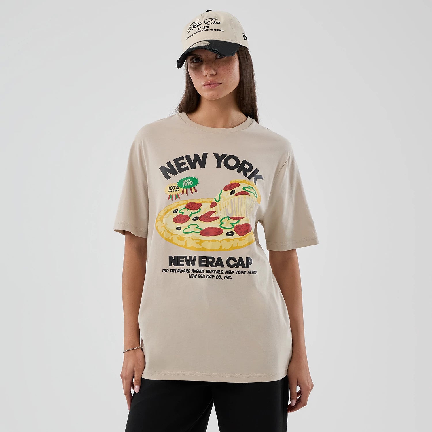 The model is wearing this New Era Pizza Graphic T-Shirt in light beige. 4