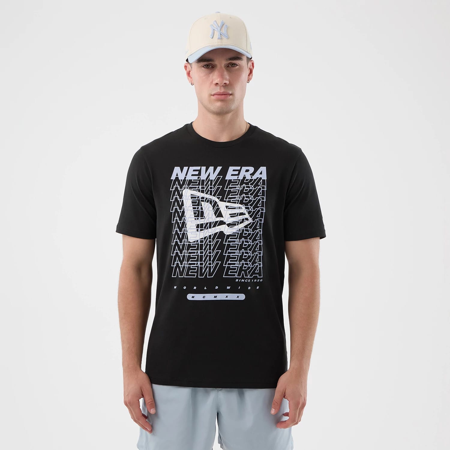 The model is wearing this New Era Logo Graphic T-Shirt in black. 1