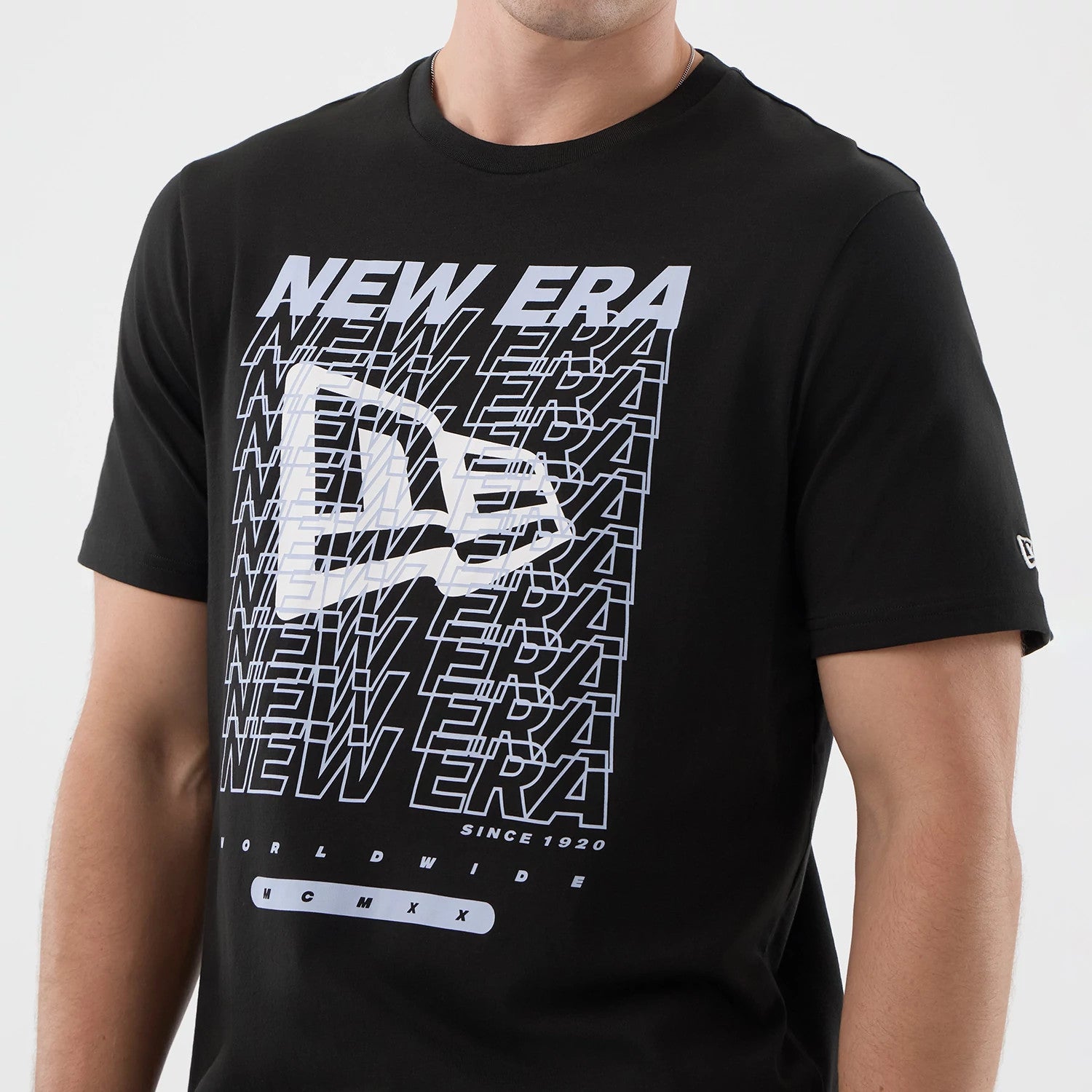 The model is wearing this New Era Logo Graphic T-Shirt in black. 4
