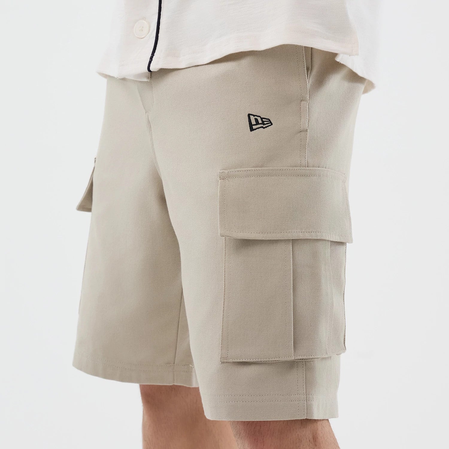 The model is wearing this New Era Cargo Shorts in light beige. 3