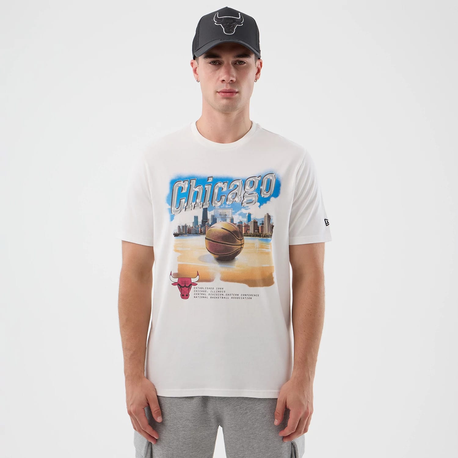The model is wearing this NBA Beach Graphic Chicago Bulls T-Shirt in white. 1