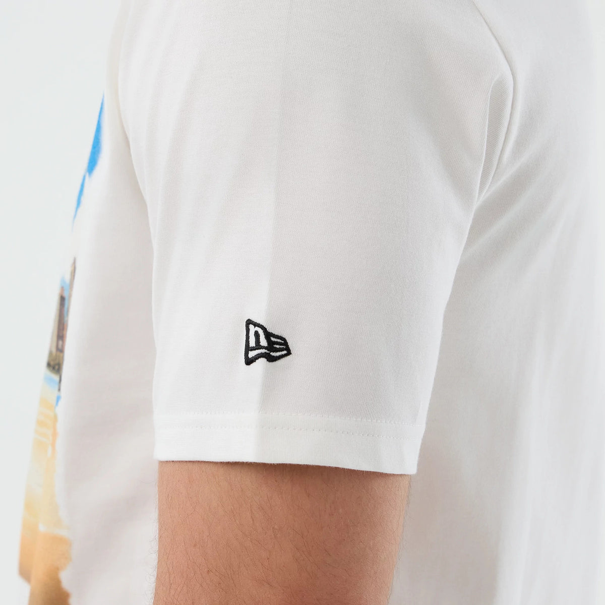 New Era Chicago Bulls NBA Beach Graphic White T-Shirt, side view showing the embroidered New Era logo on the sleeve with a beach graphic on the front, highlighting the crisp white fabric of the T-shirt.
