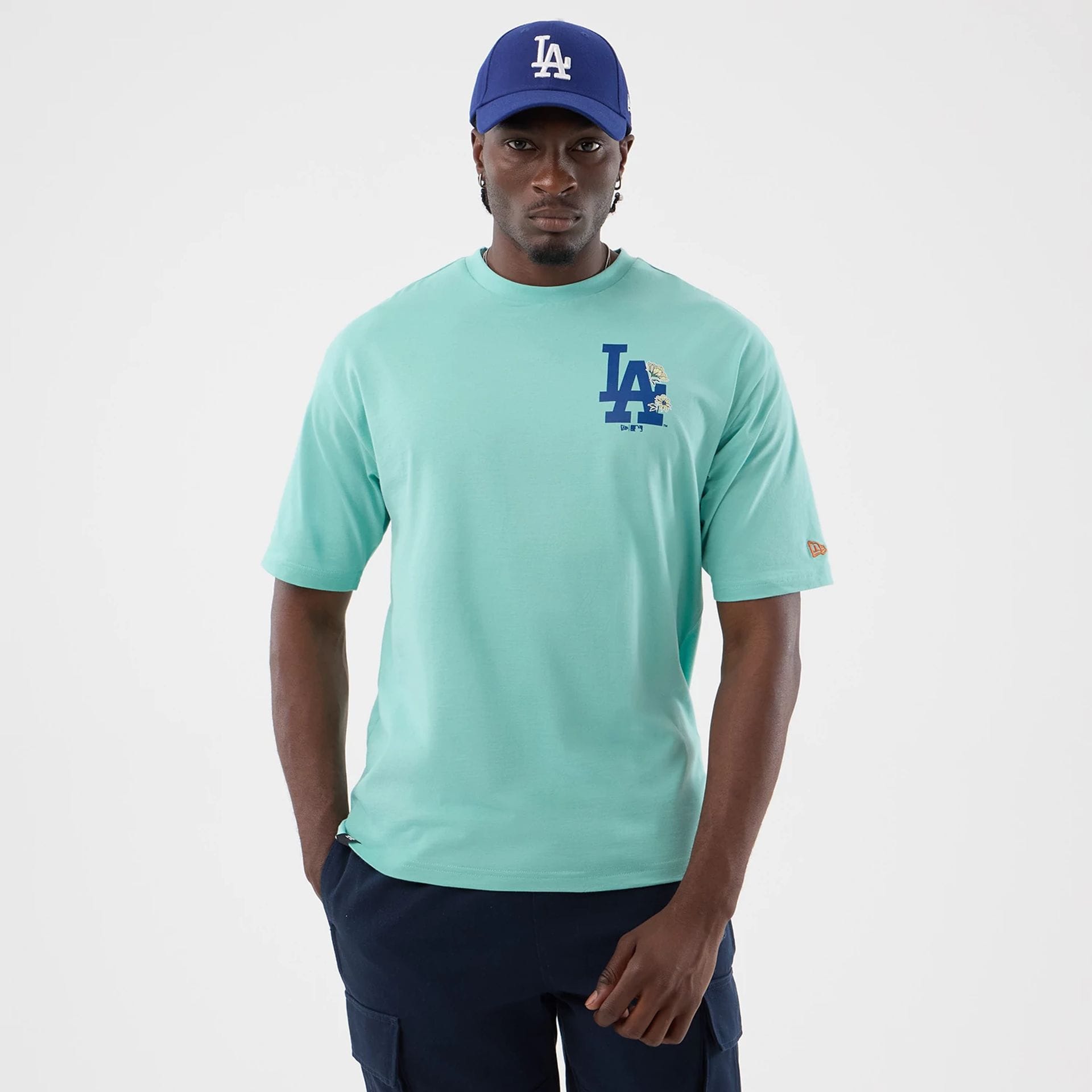 The model is wearing this MLB Floral LA Dodgers Oversized T-Shirt in pastel green. 1