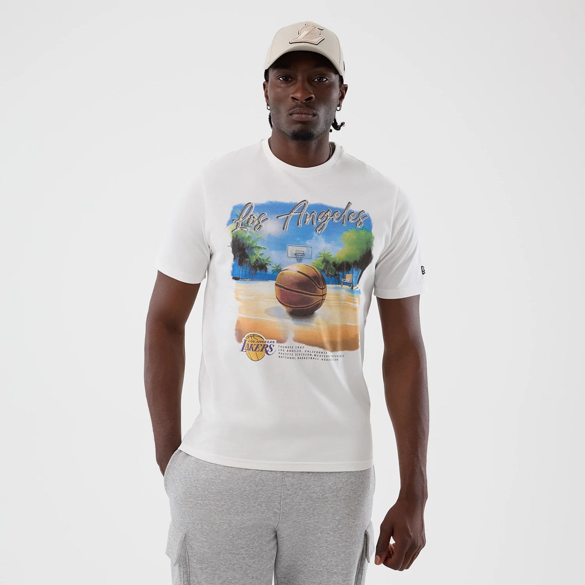 The model is wearing this NBA Beach Graphic LA Lakers T-Shirt in white. 1